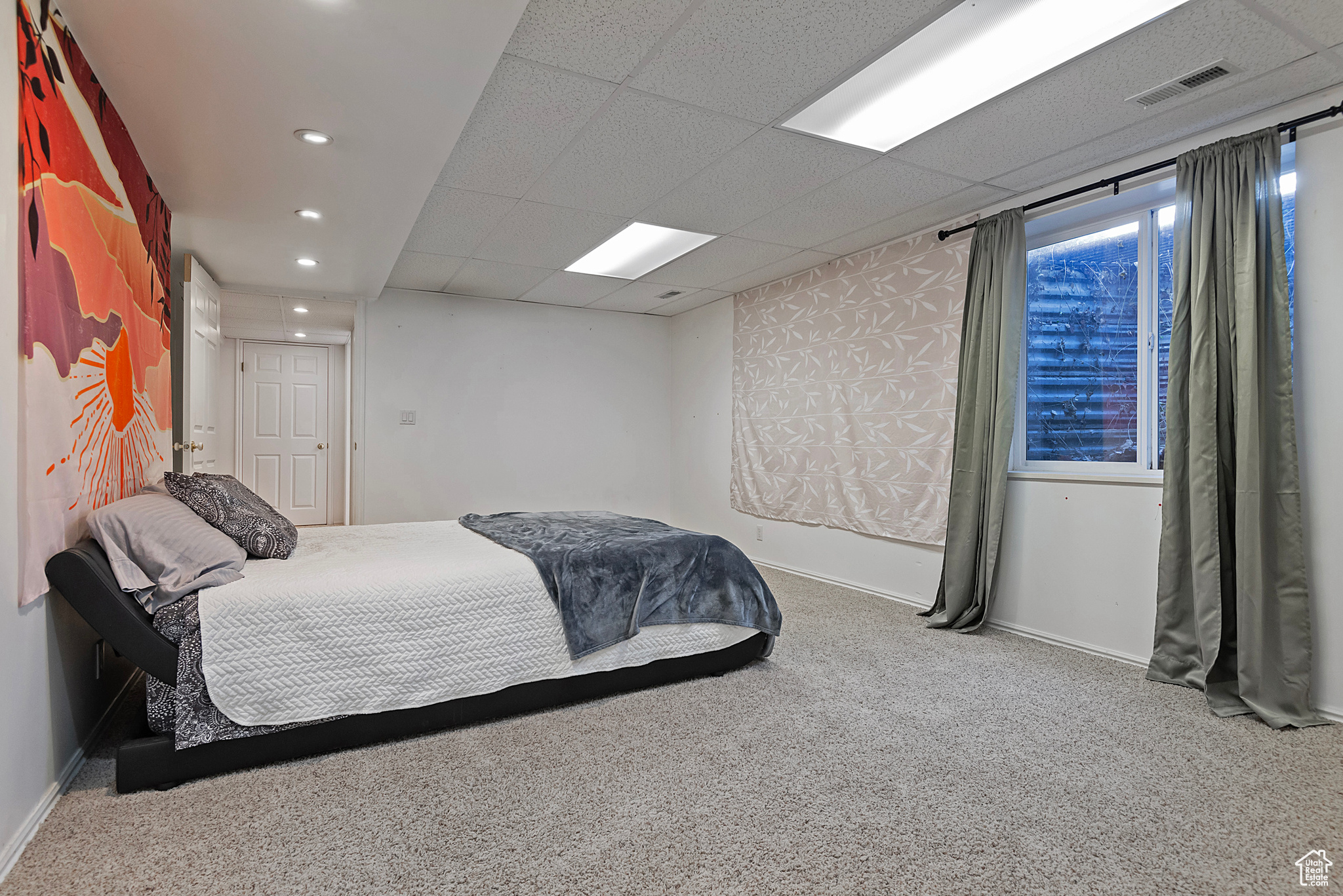 Carpeted bedroom with a drop ceiling