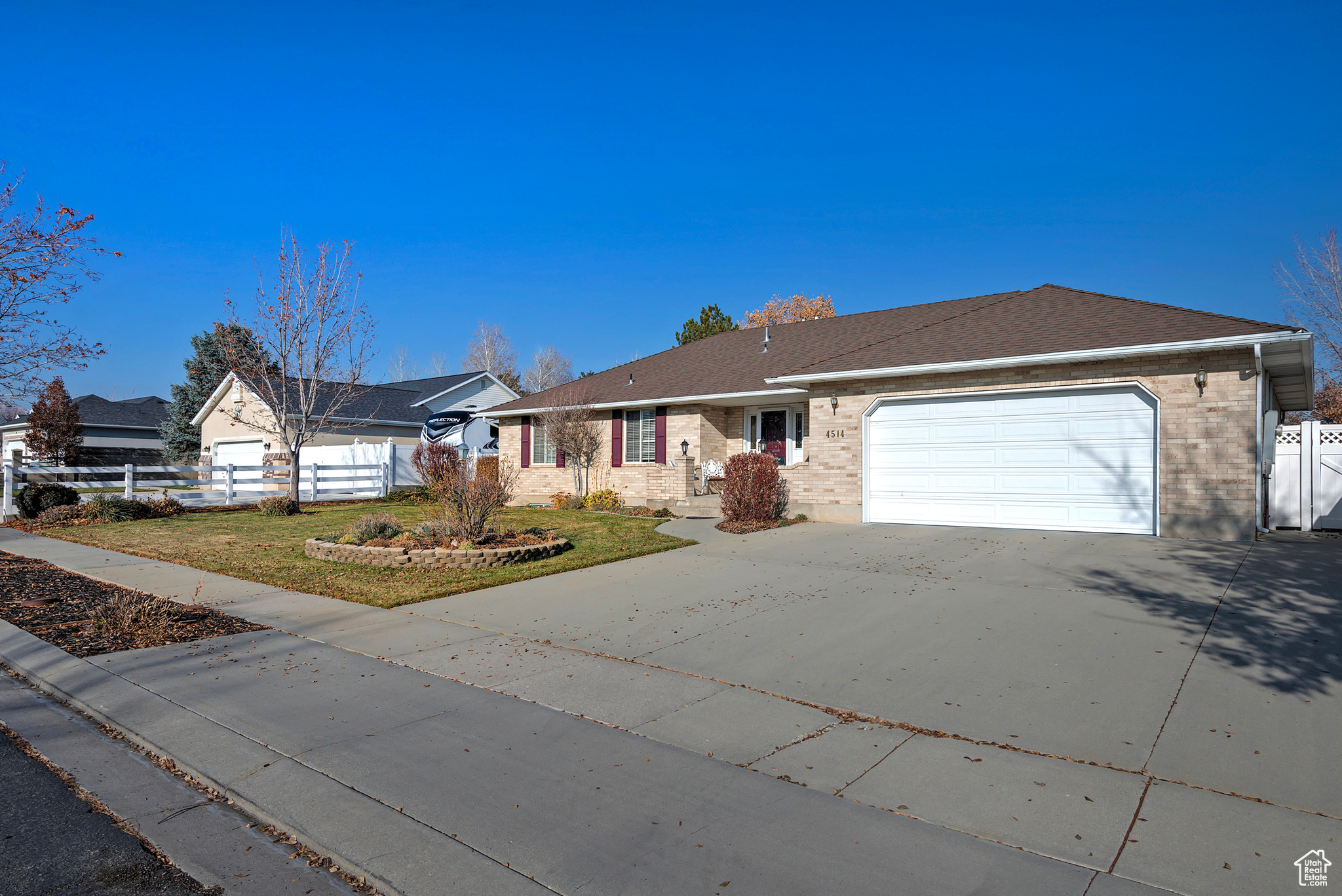 Ranch-style home with a front lawn and a garage