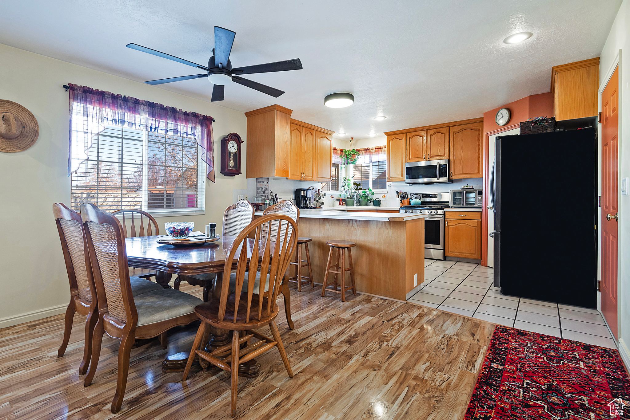 Dining space with light tile patterned floors and ceiling fan