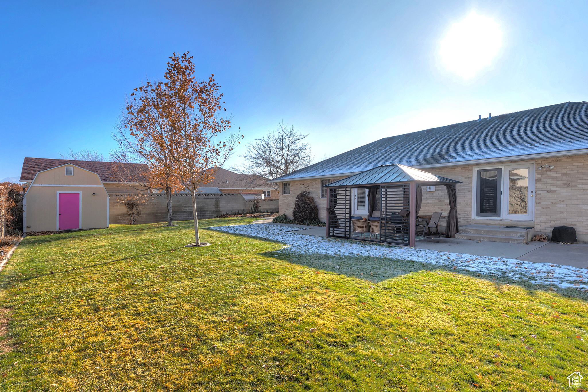 Back of property with a gazebo, a lawn, a patio, and a storage shed