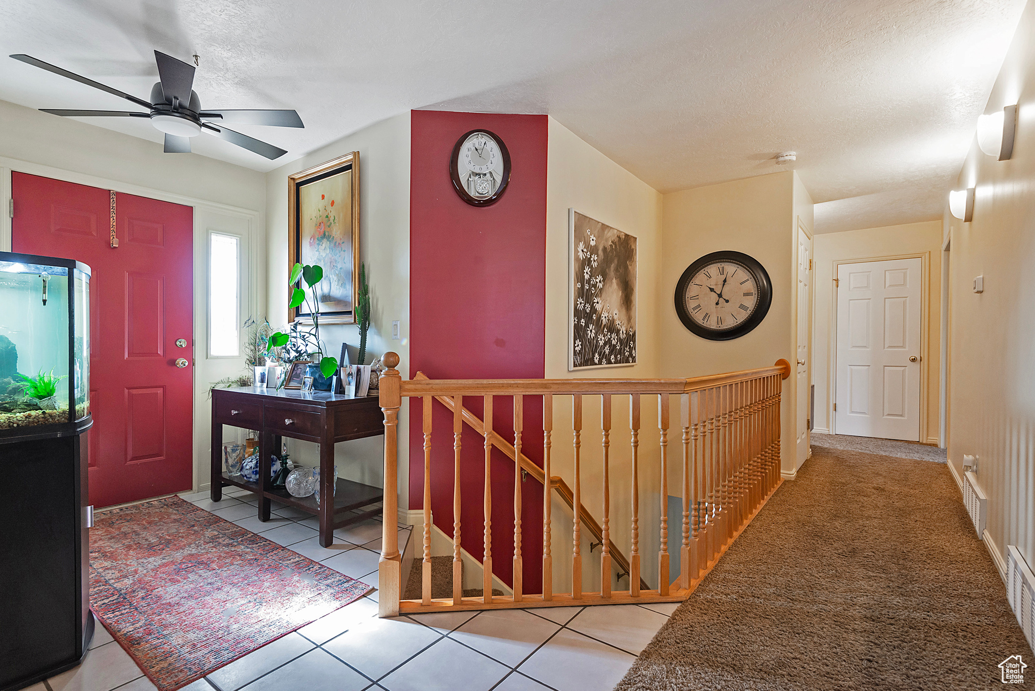 Tiled foyer with a textured ceiling and ceiling fan