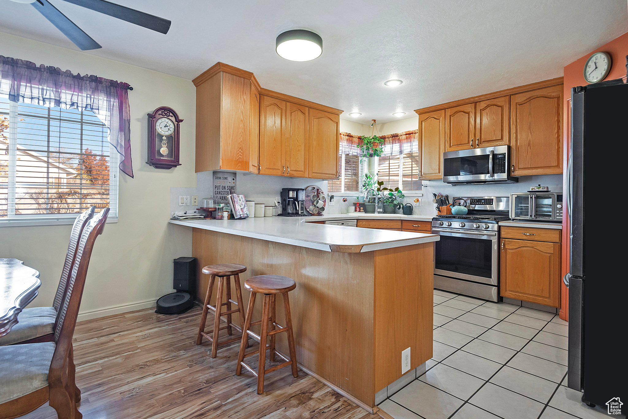 Kitchen with plenty of natural light, a kitchen bar, kitchen peninsula, and stainless steel appliances