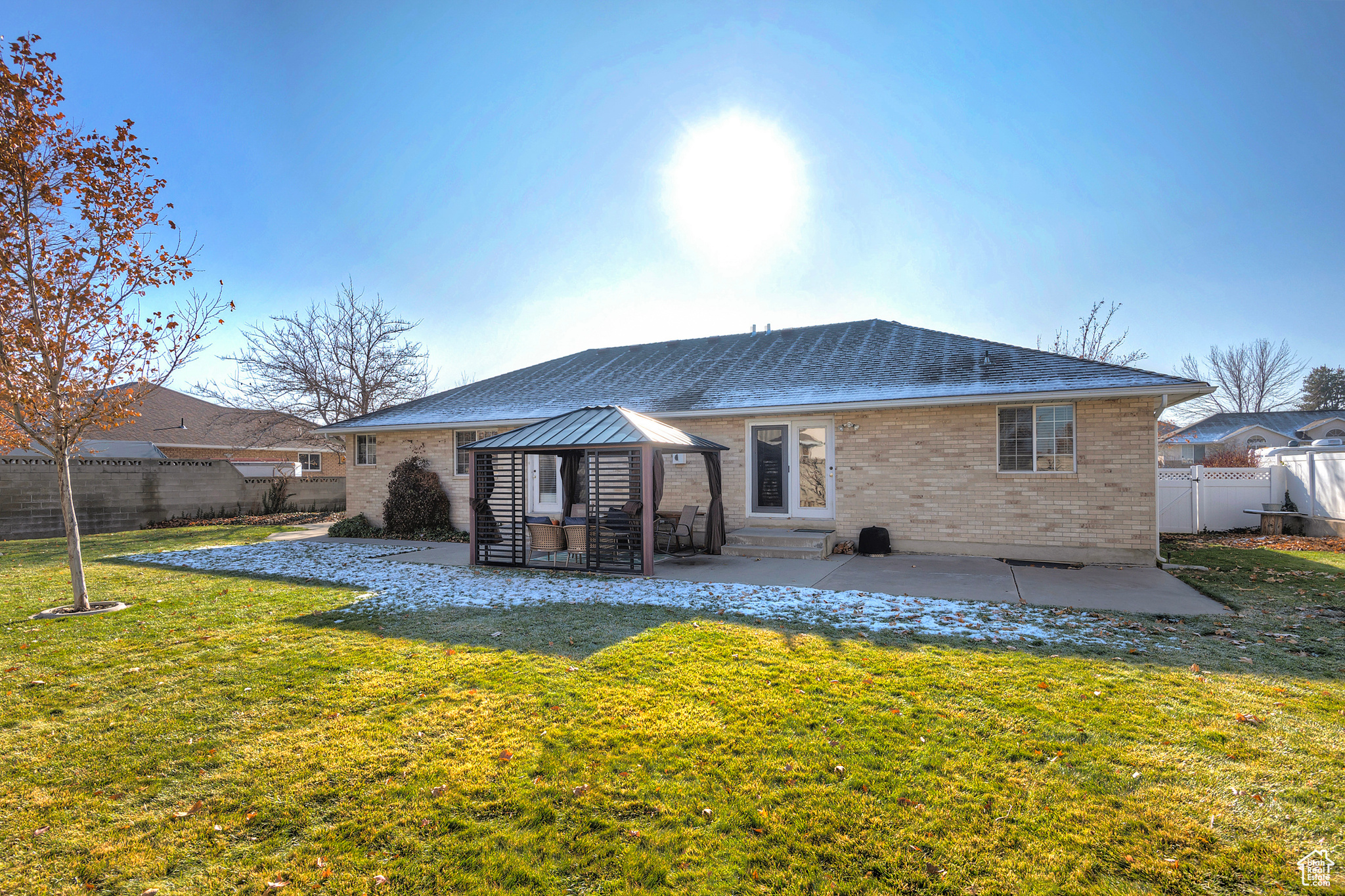 Back of property with a gazebo, a patio area, and a yard