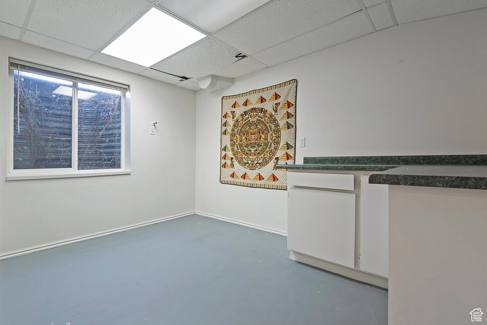 Unfurnished room featuring a drop ceiling