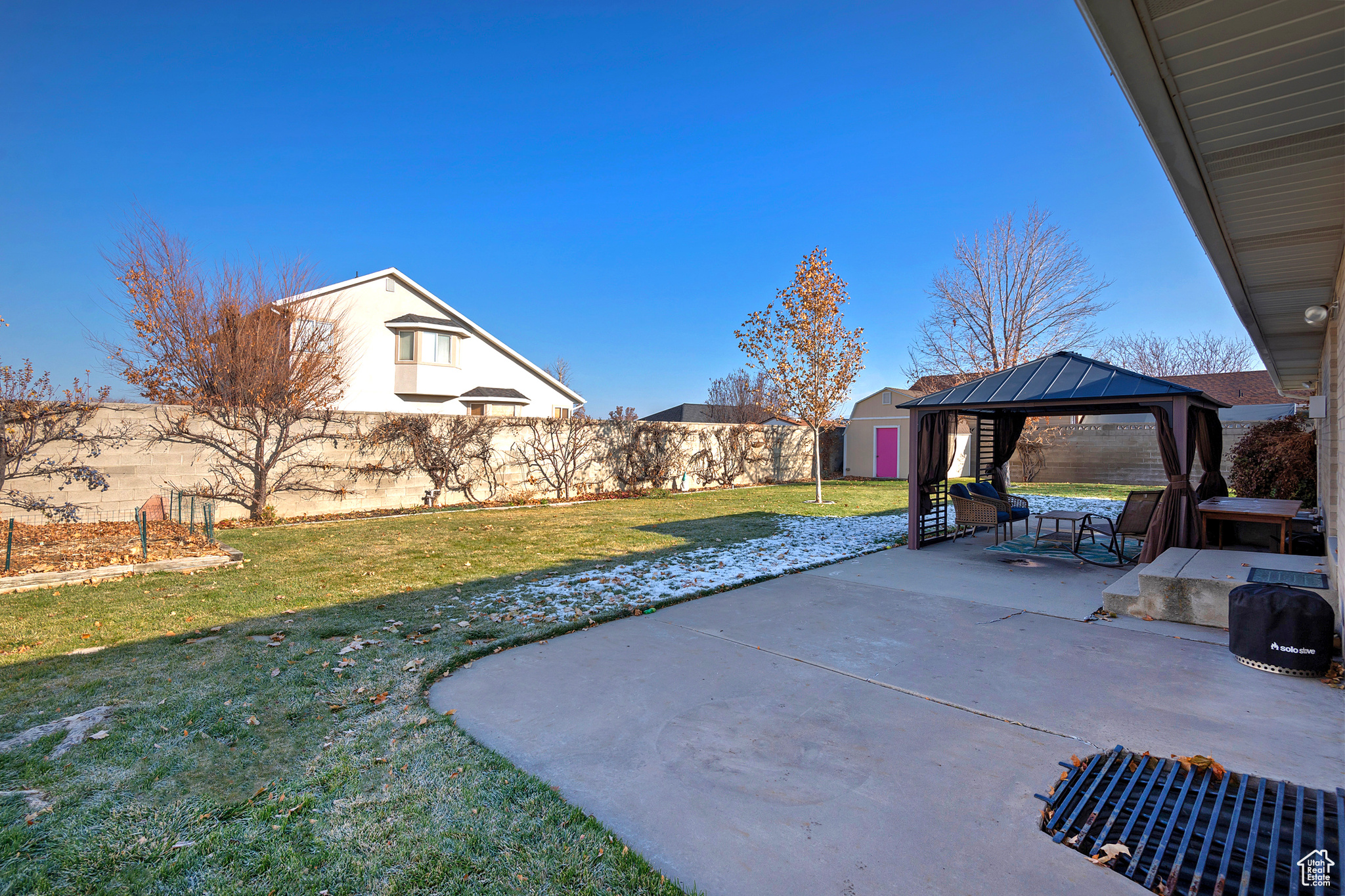 View of patio with a gazebo and a storage unit