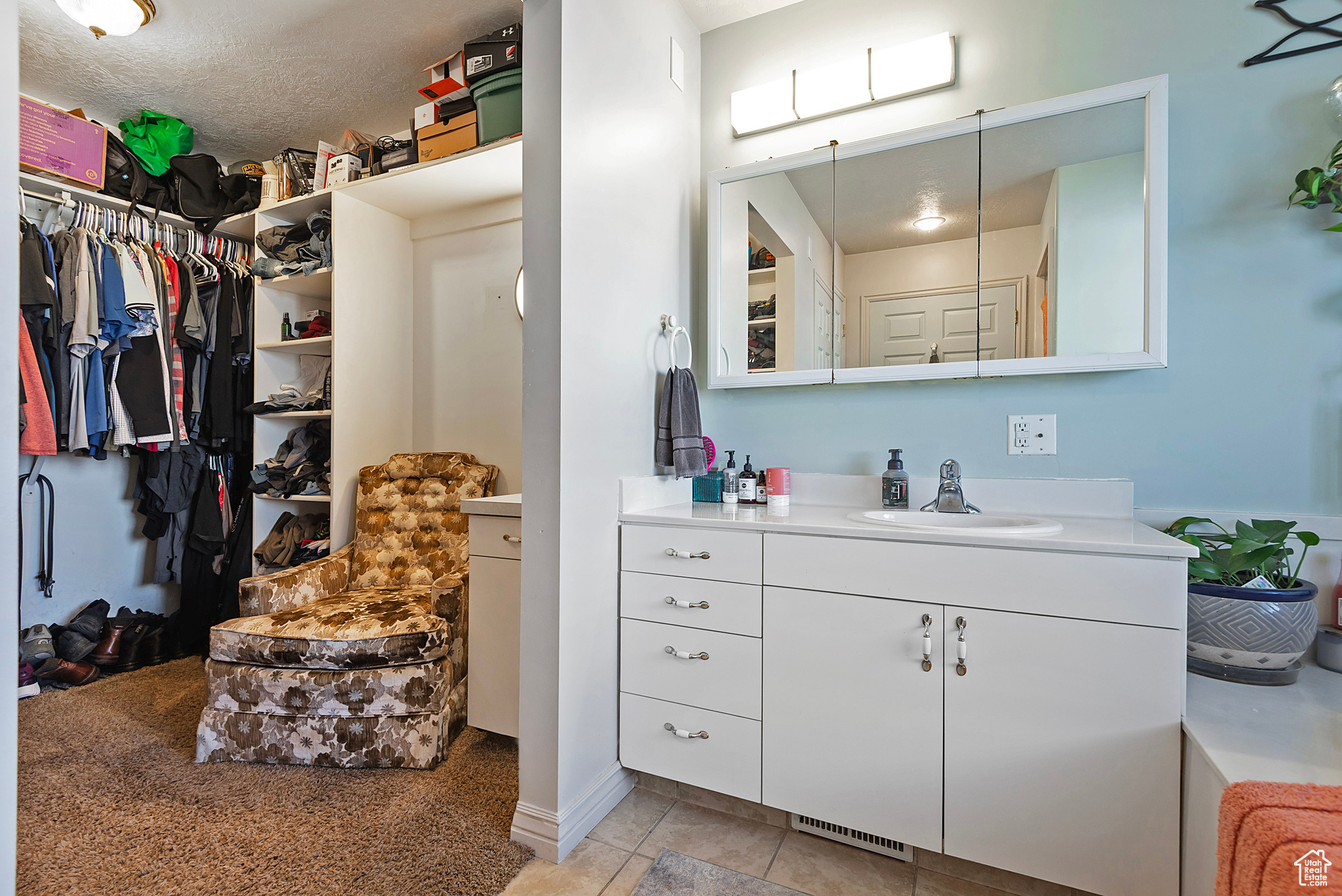 Bathroom featuring tile patterned floors, vanity, and a textured ceiling