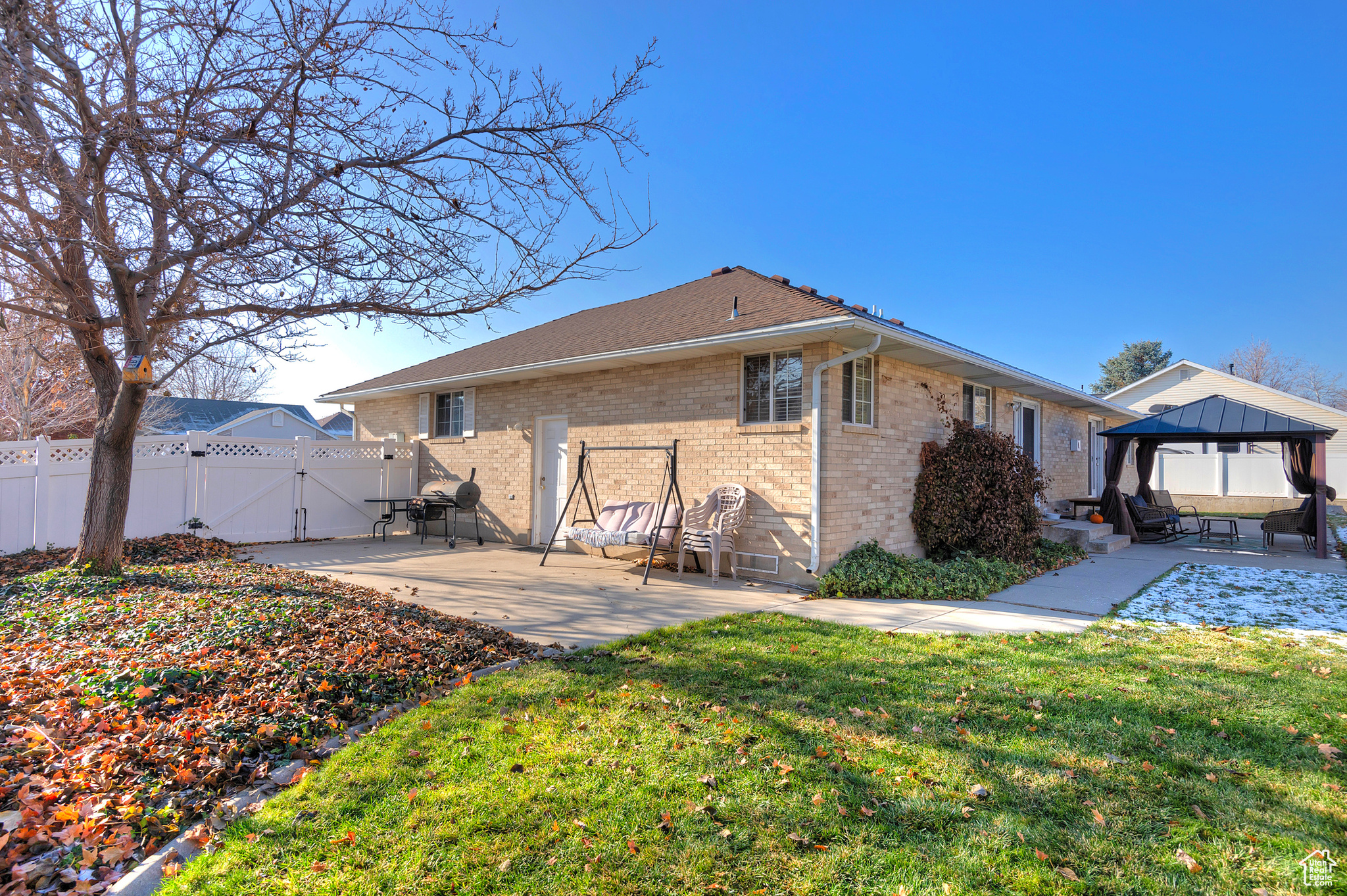 Back of property with a gazebo, a patio area, and a yard