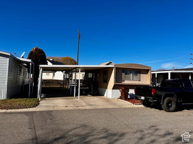 View of front of property featuring a carport