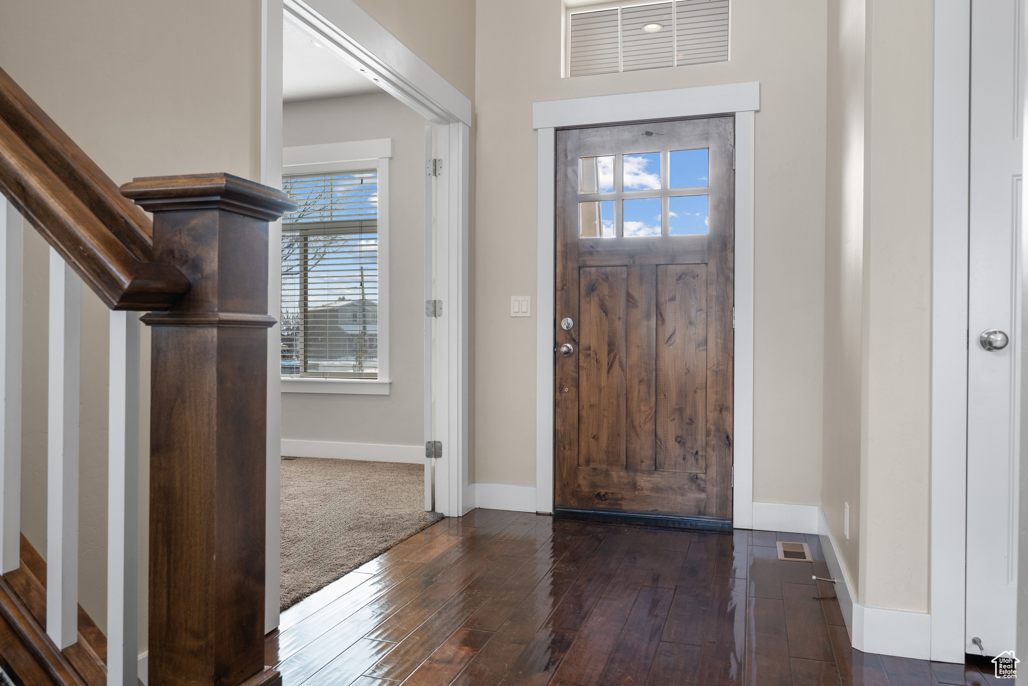 Entrance foyer featuring dark wood-type flooring