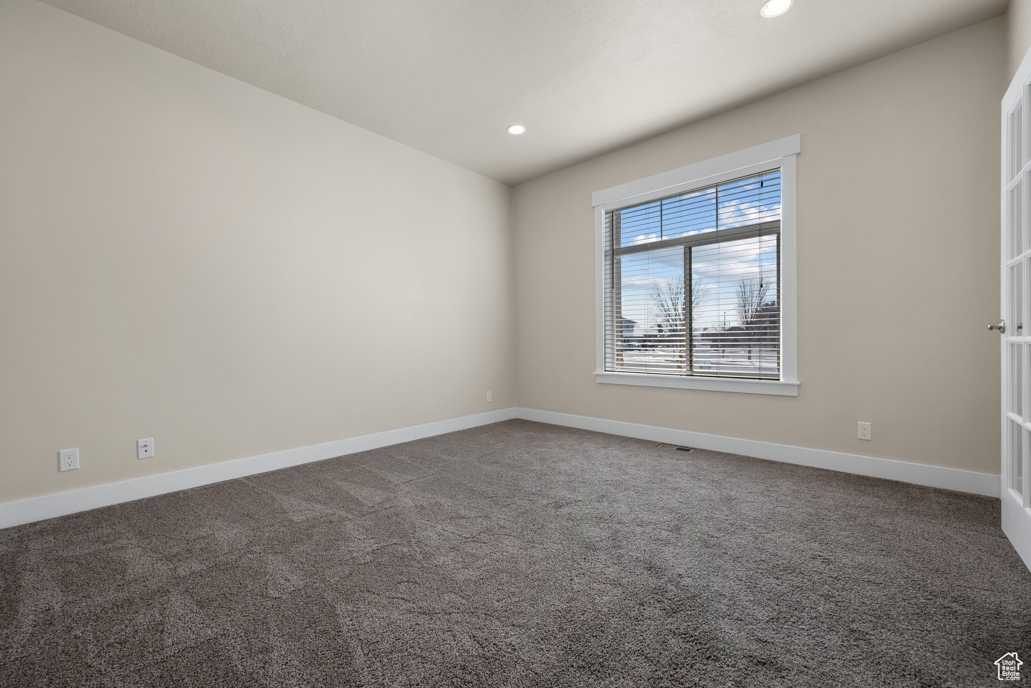 Unfurnished room featuring carpet flooring