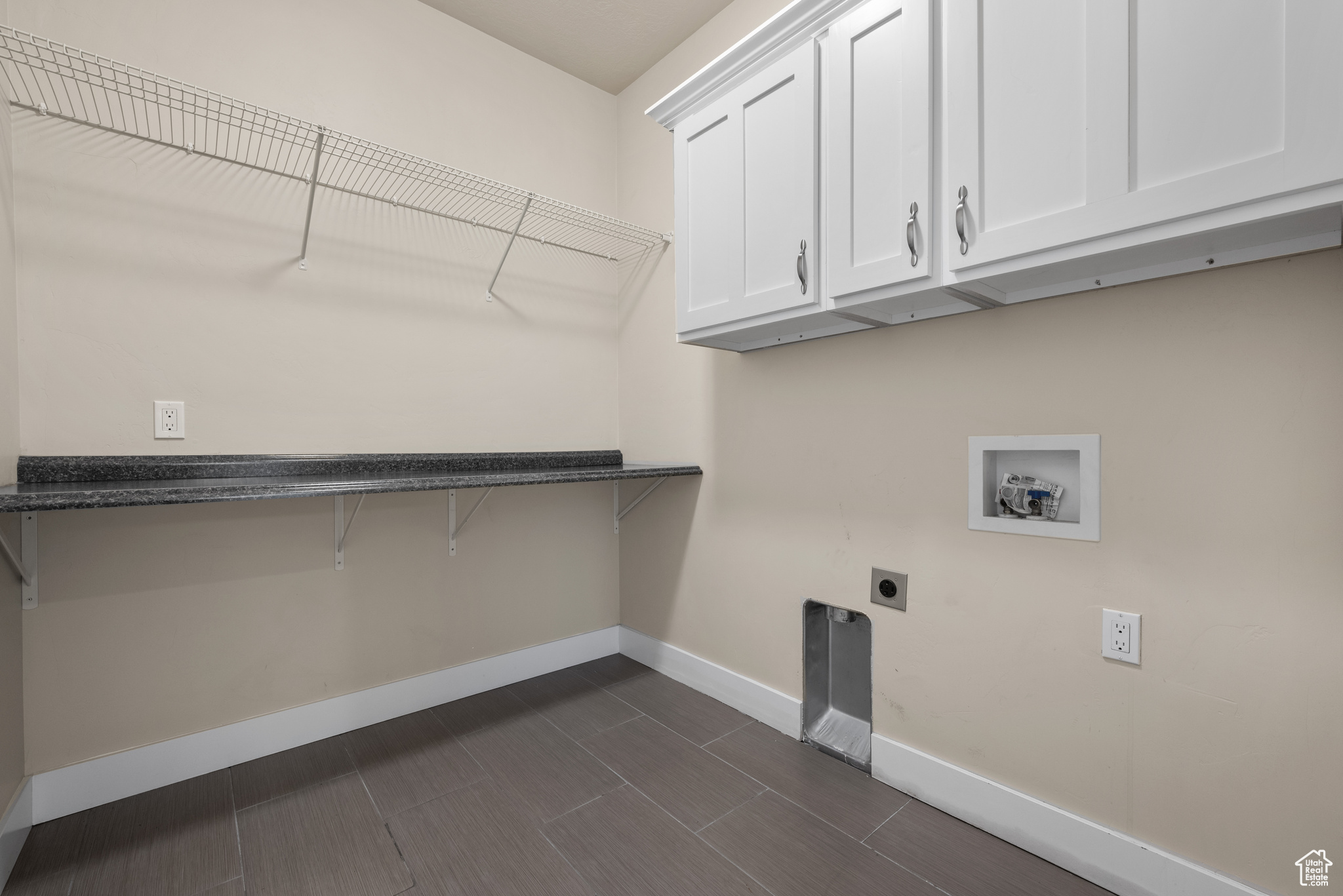 Laundry room featuring electric dryer hookup, washer hookup, and cabinets