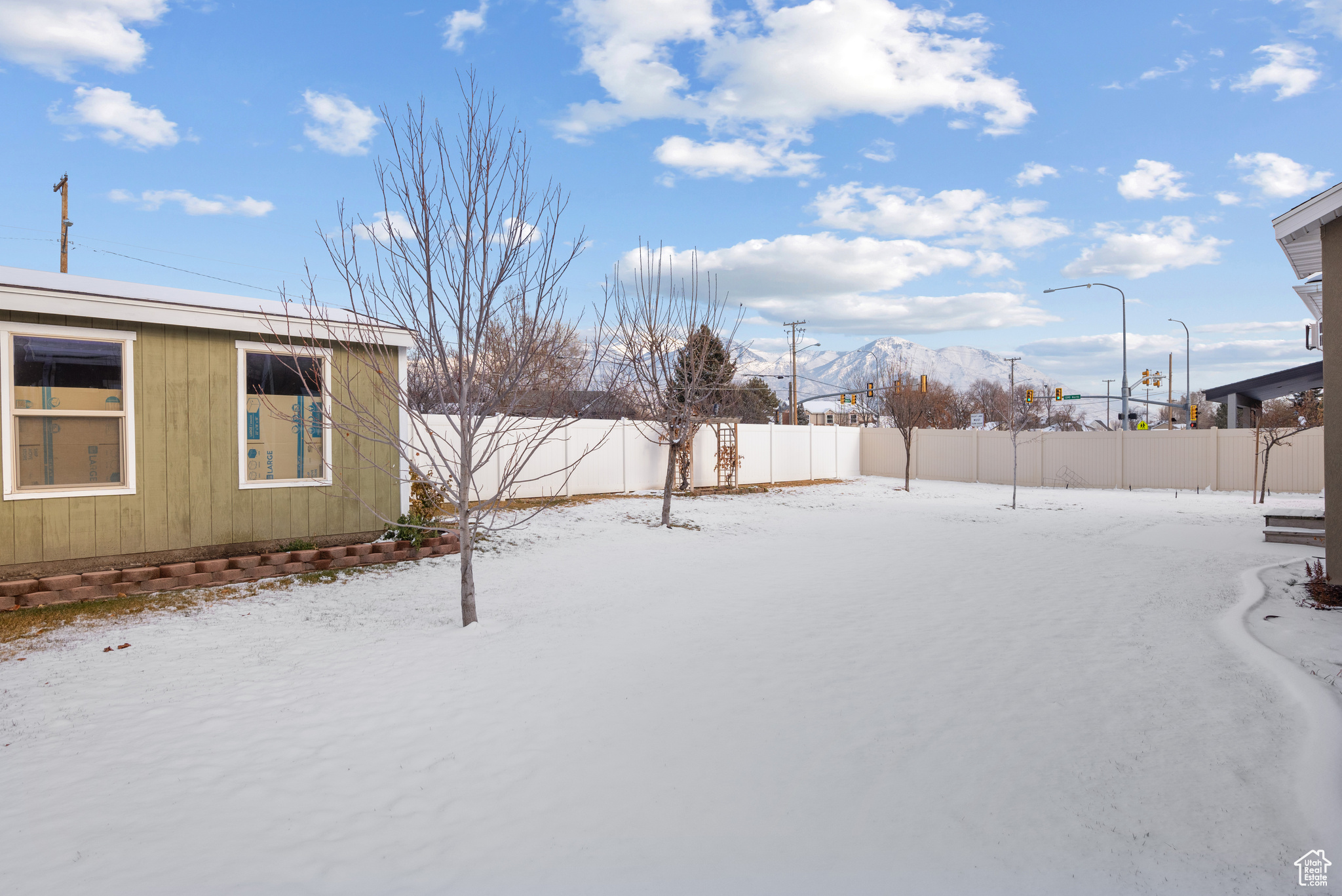 Yard covered in snow with a mountain view