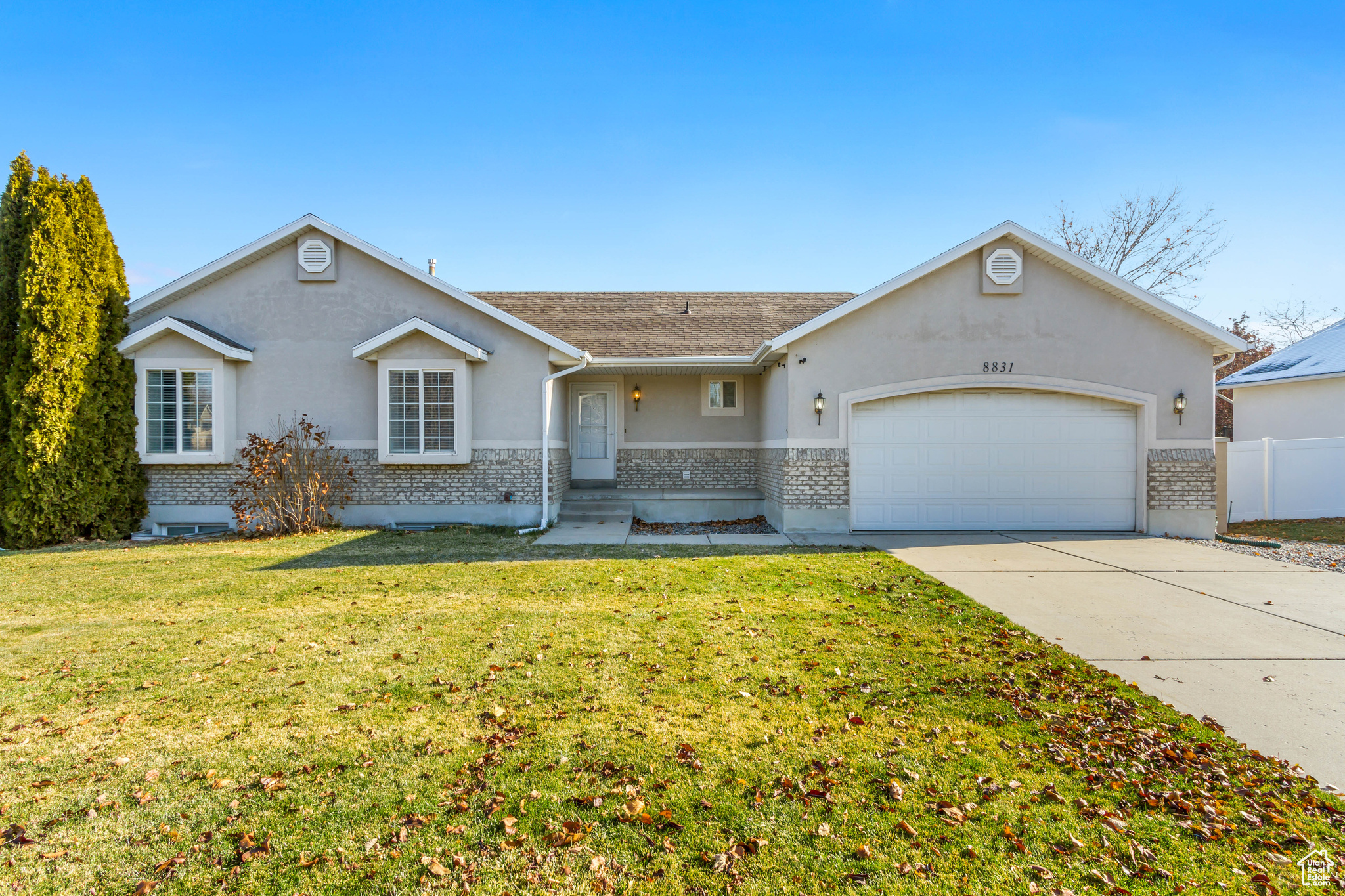 Single story home with a garage and a front yard