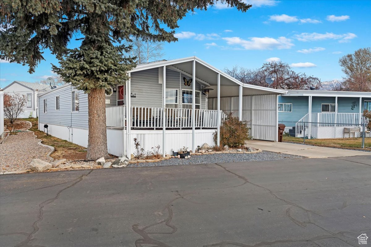 Manufactured / mobile home featuring a carport and covered porch