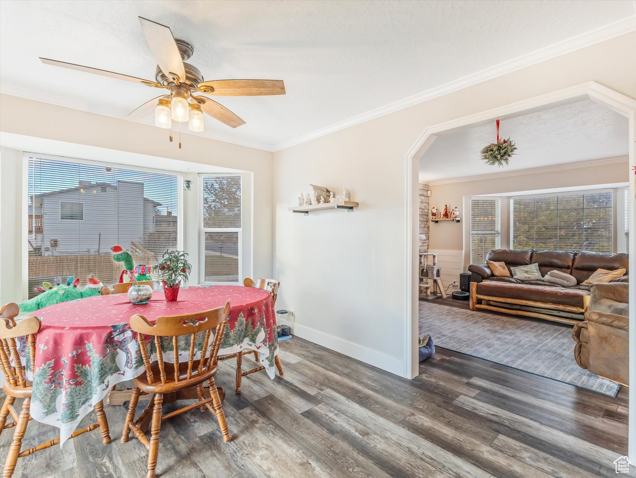 Dining space with dark hardwood / wood-style floors, ceiling fan, and ornamental molding