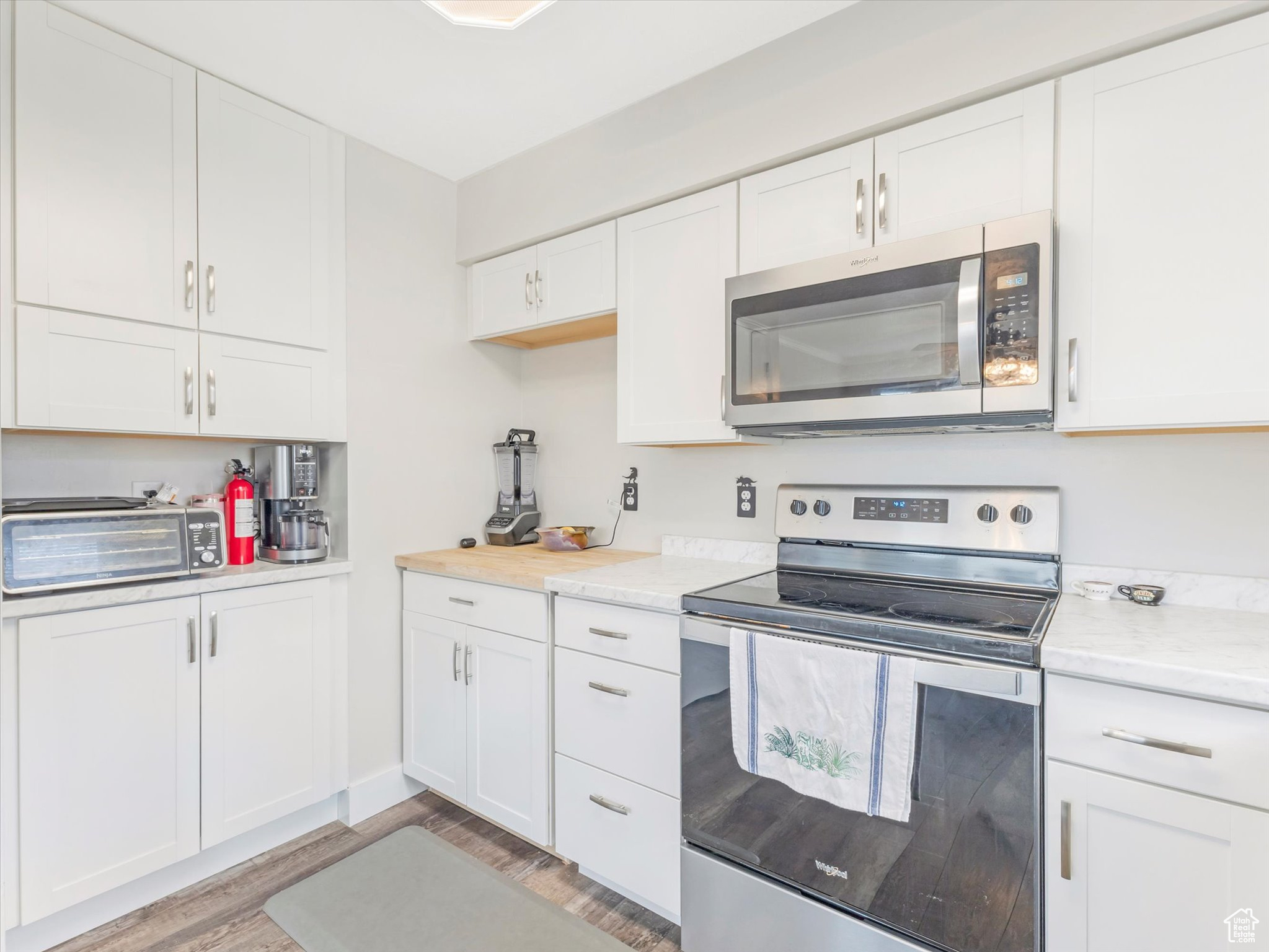 Kitchen with stainless steel appliances and white cabinetry