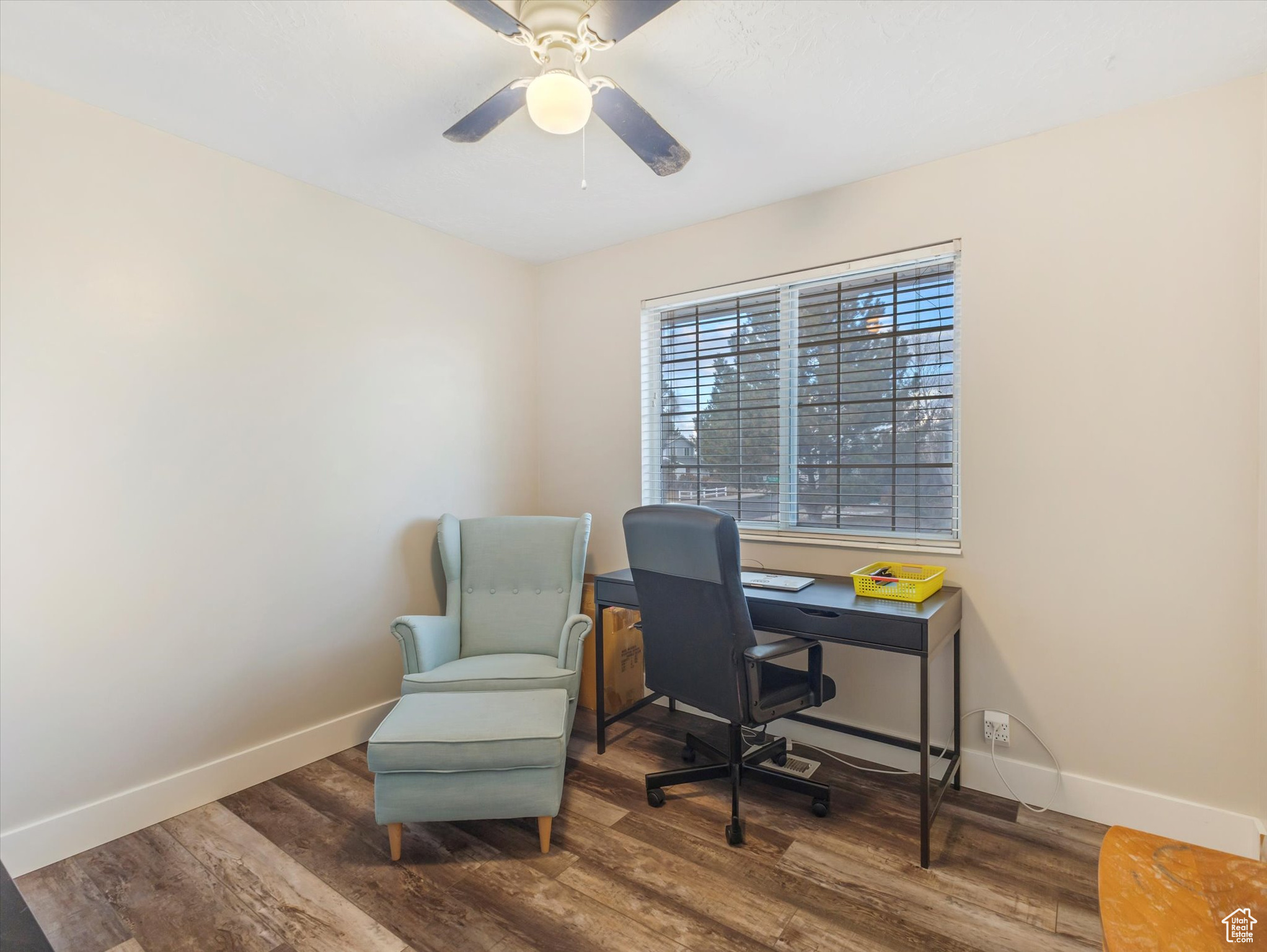 Office area with ceiling fan and dark hardwood / wood-style floors