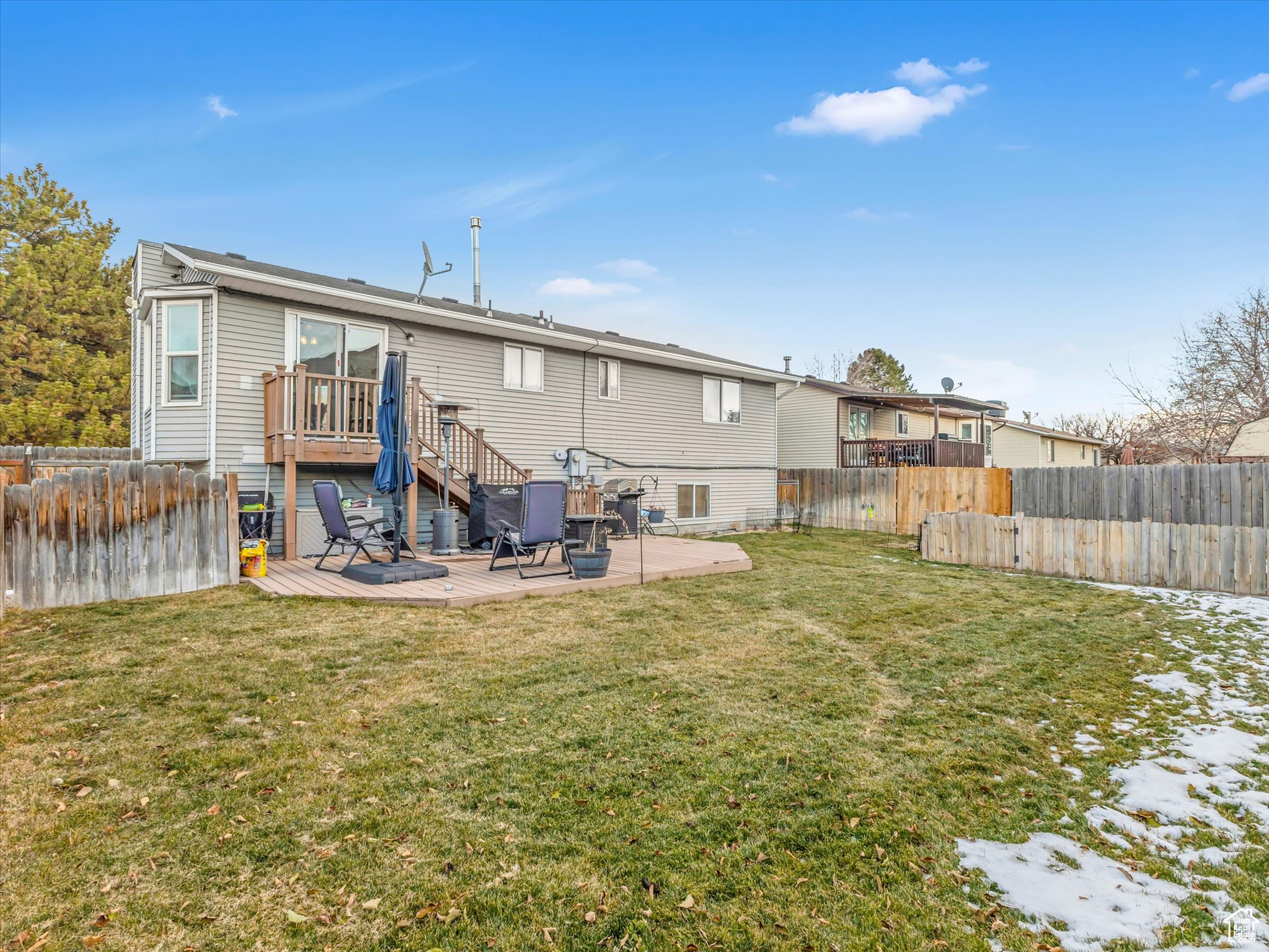 Back of house with a patio area, a yard, and a deck