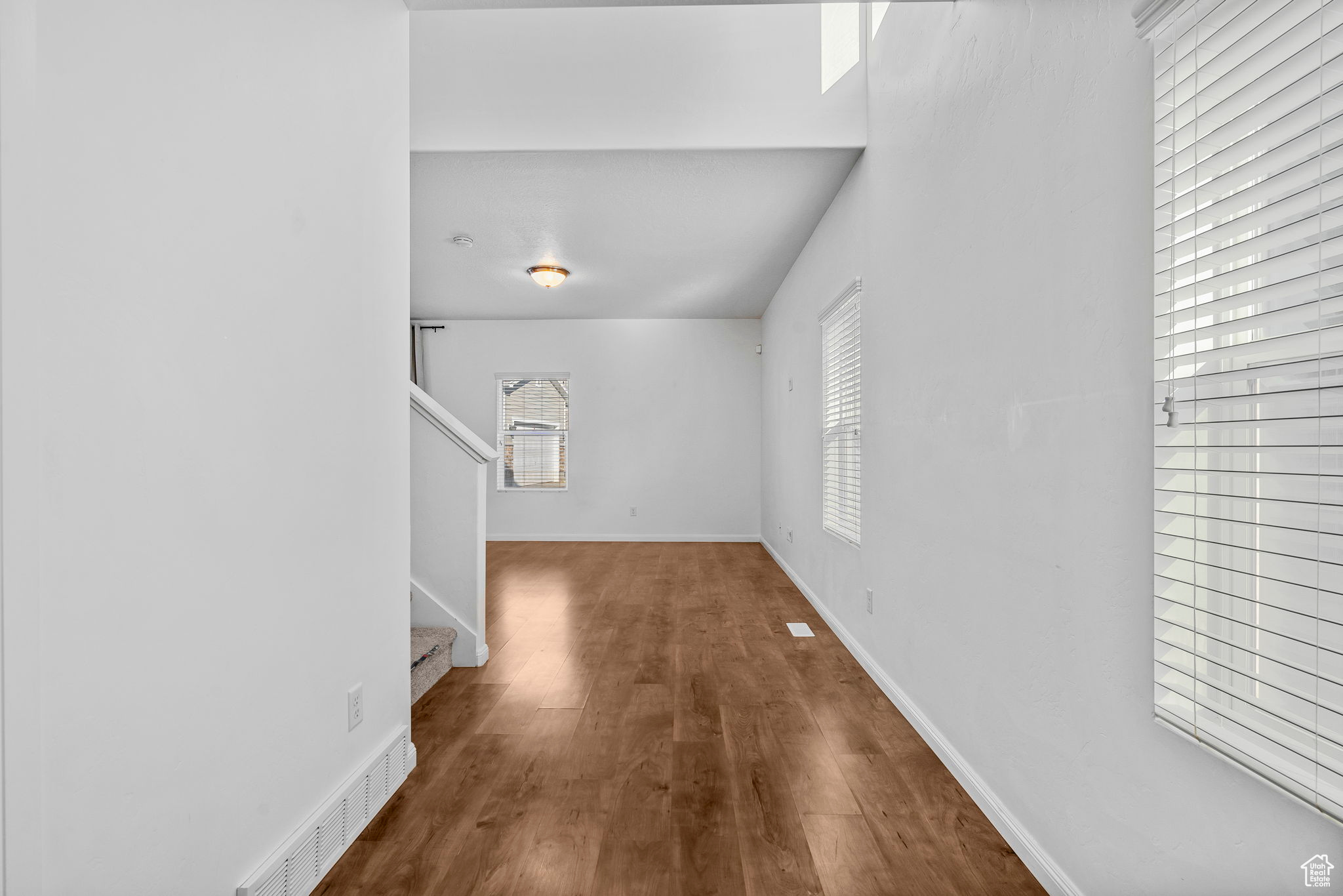 Unfurnished living room featuring dark hardwood / wood-style flooring