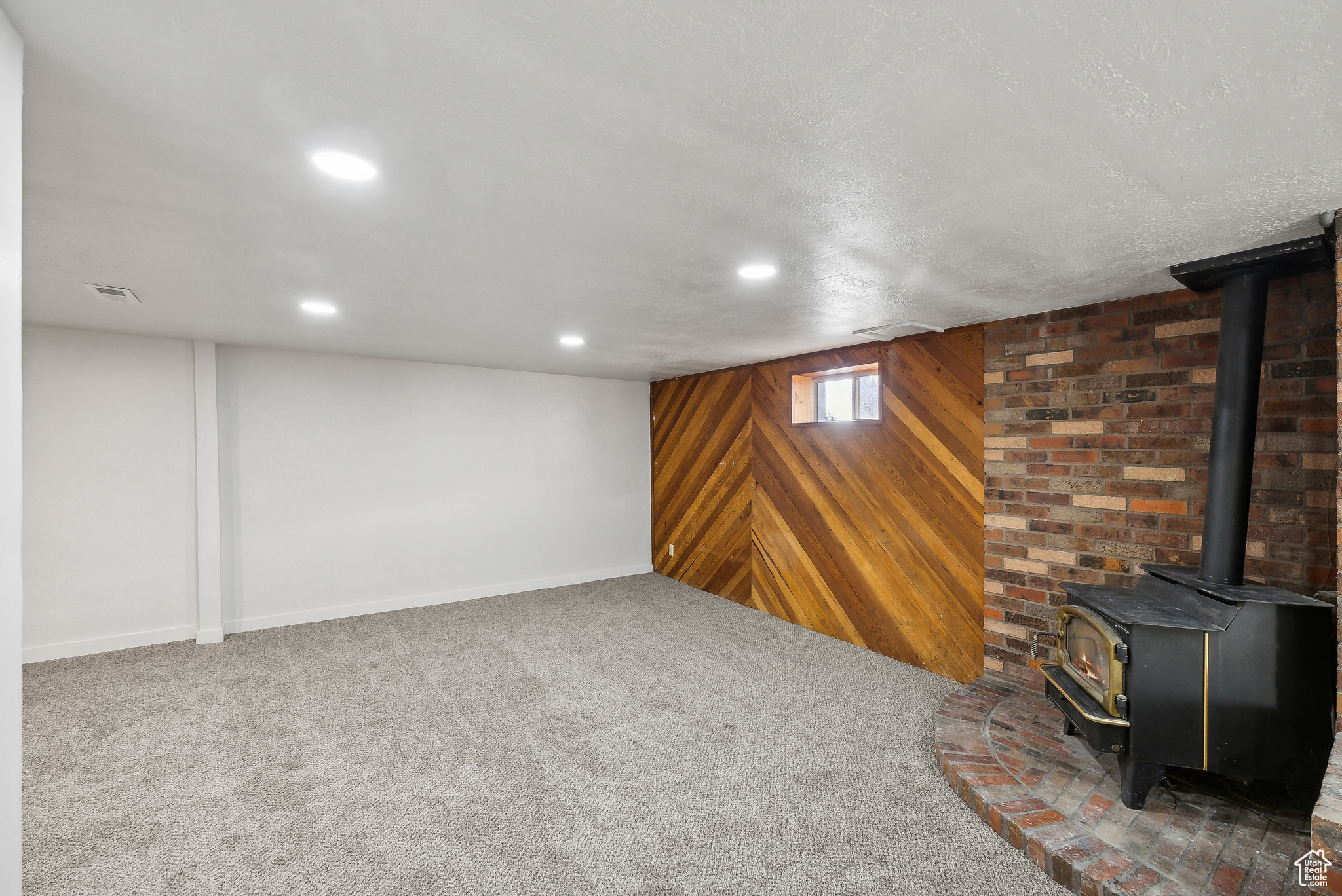 Basement featuring dark carpet and wooden walls