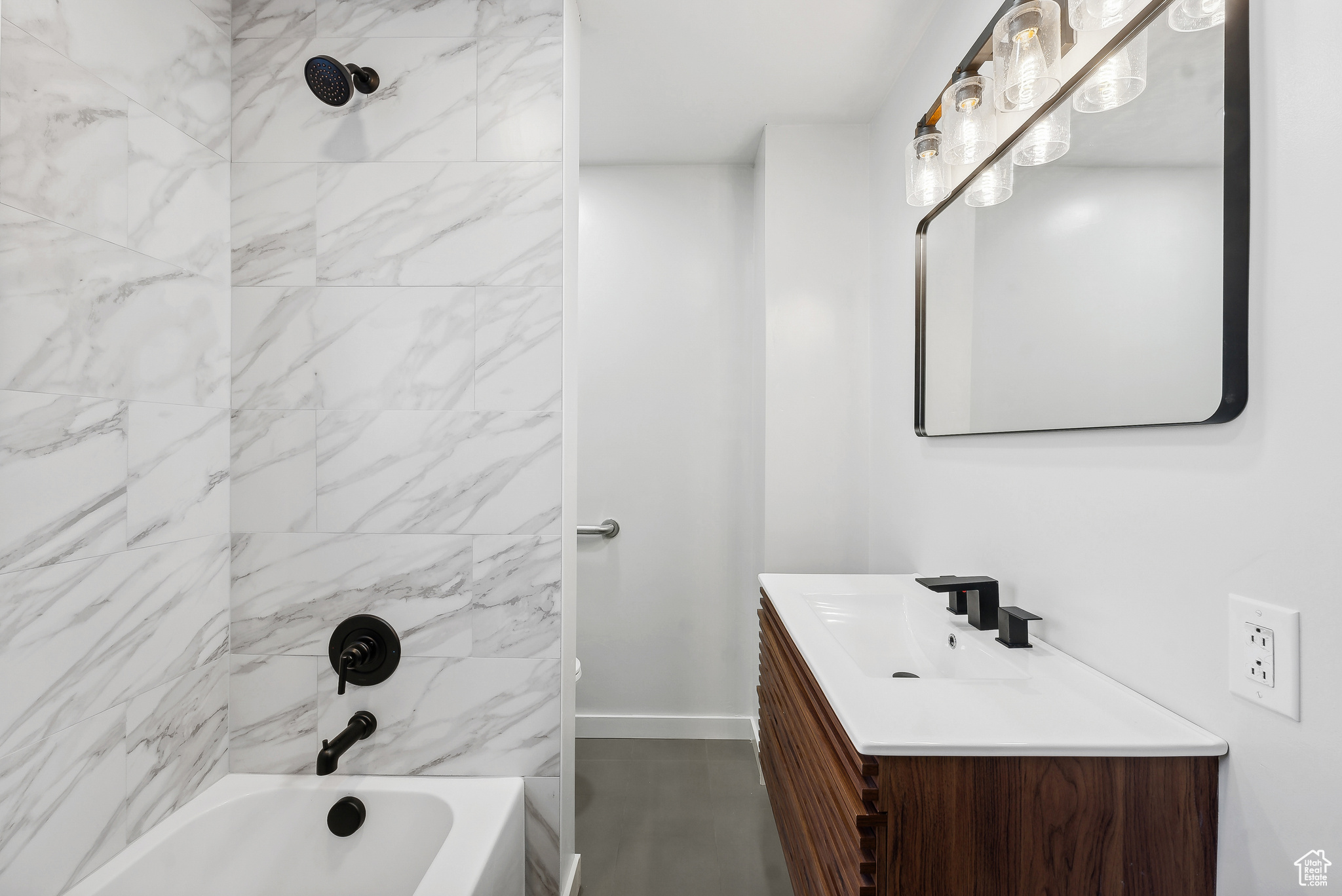 Bathroom with vanity and tiled shower / bath