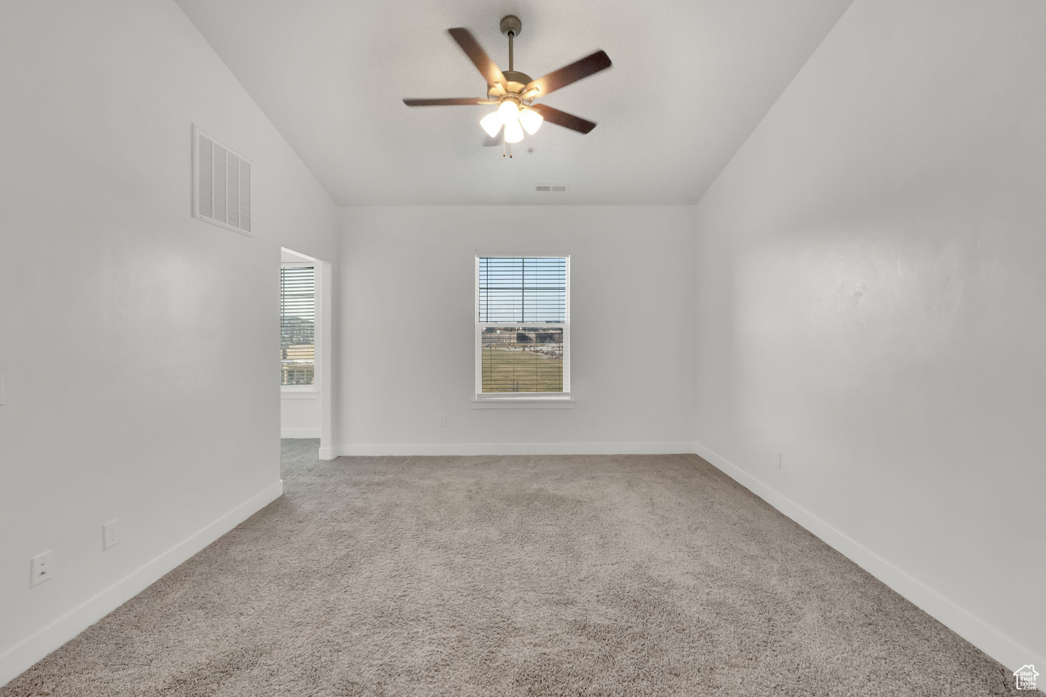 Family room featuring ceiling fan and vaulted ceiling