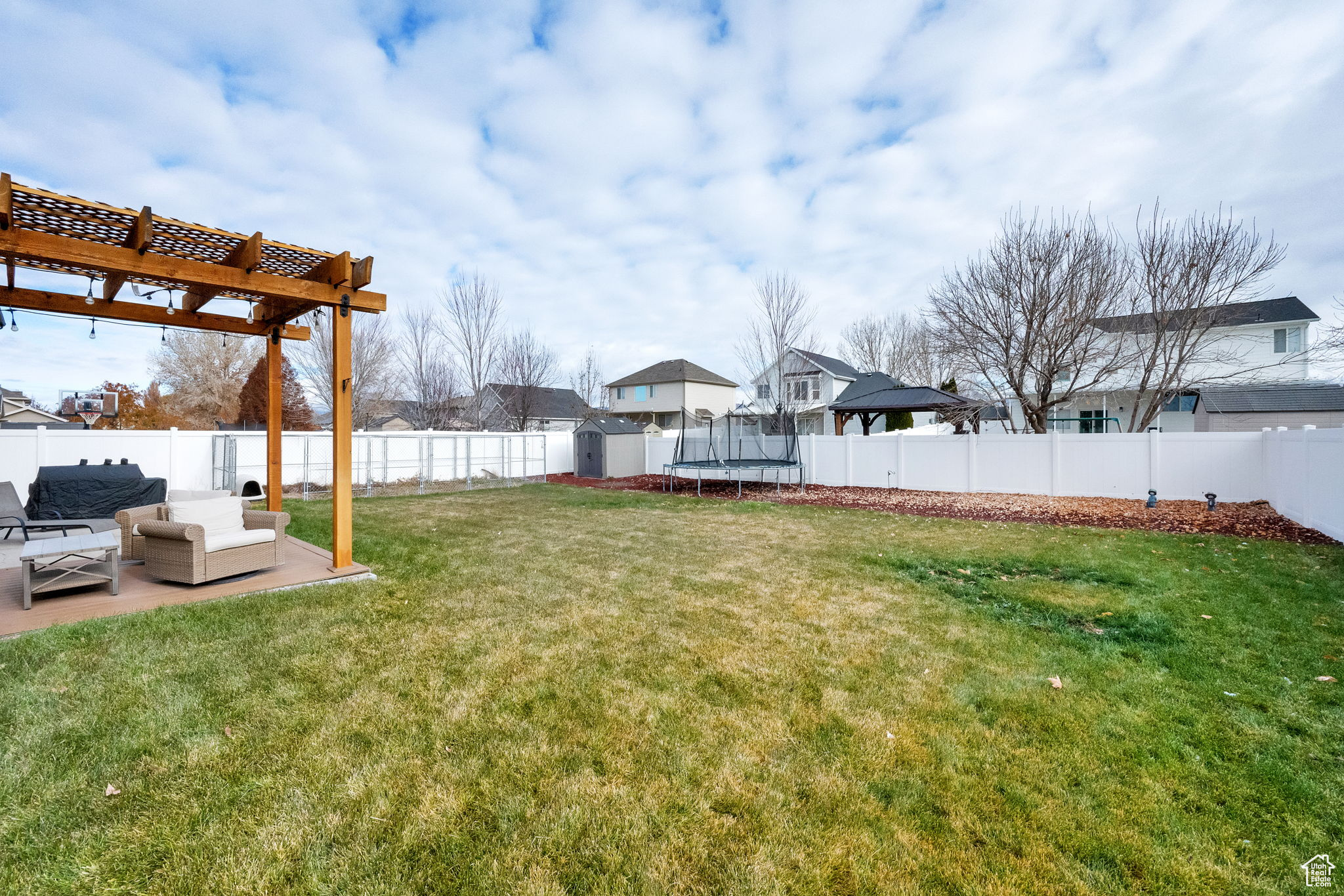 View of yard with a pergola, outdoor lounge area, and a trampoline