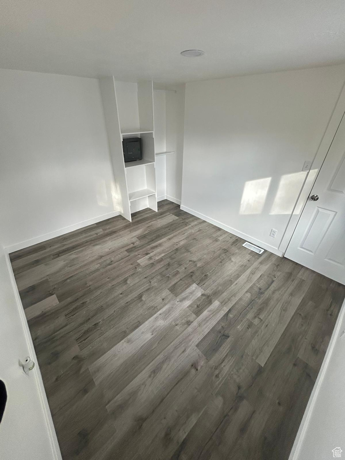 Interior space featuring dark wood-type flooring