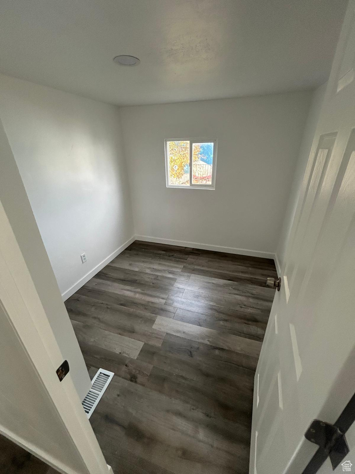 Spare room featuring dark hardwood / wood-style floors