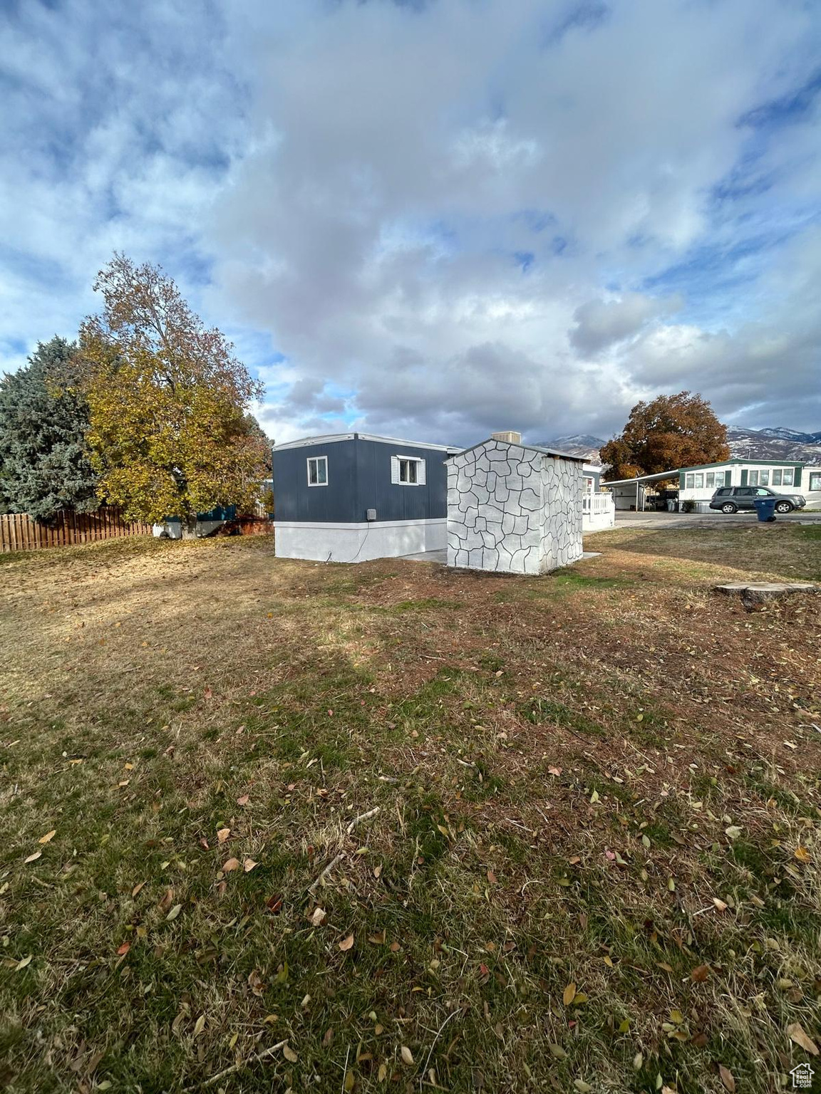 View of property exterior with a yard