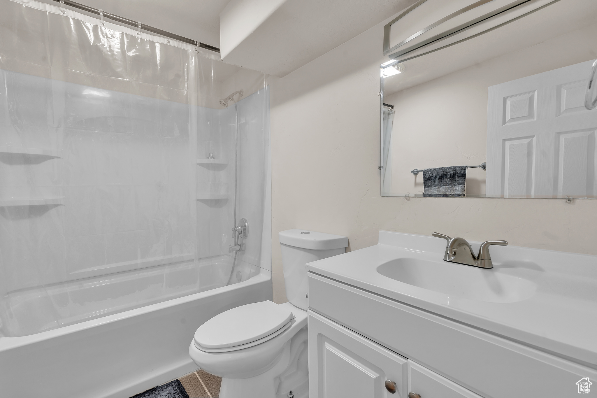 Full bathroom featuring vanity, toilet, and shower / bath combo with shower curtain