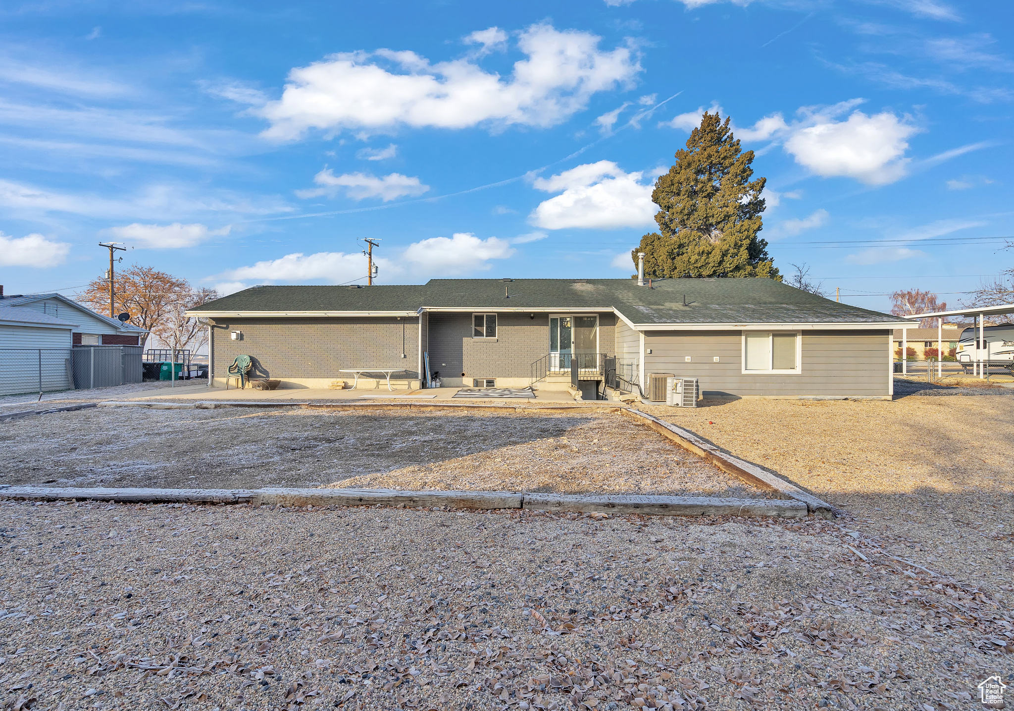 View of front of home with central AC unit and a patio