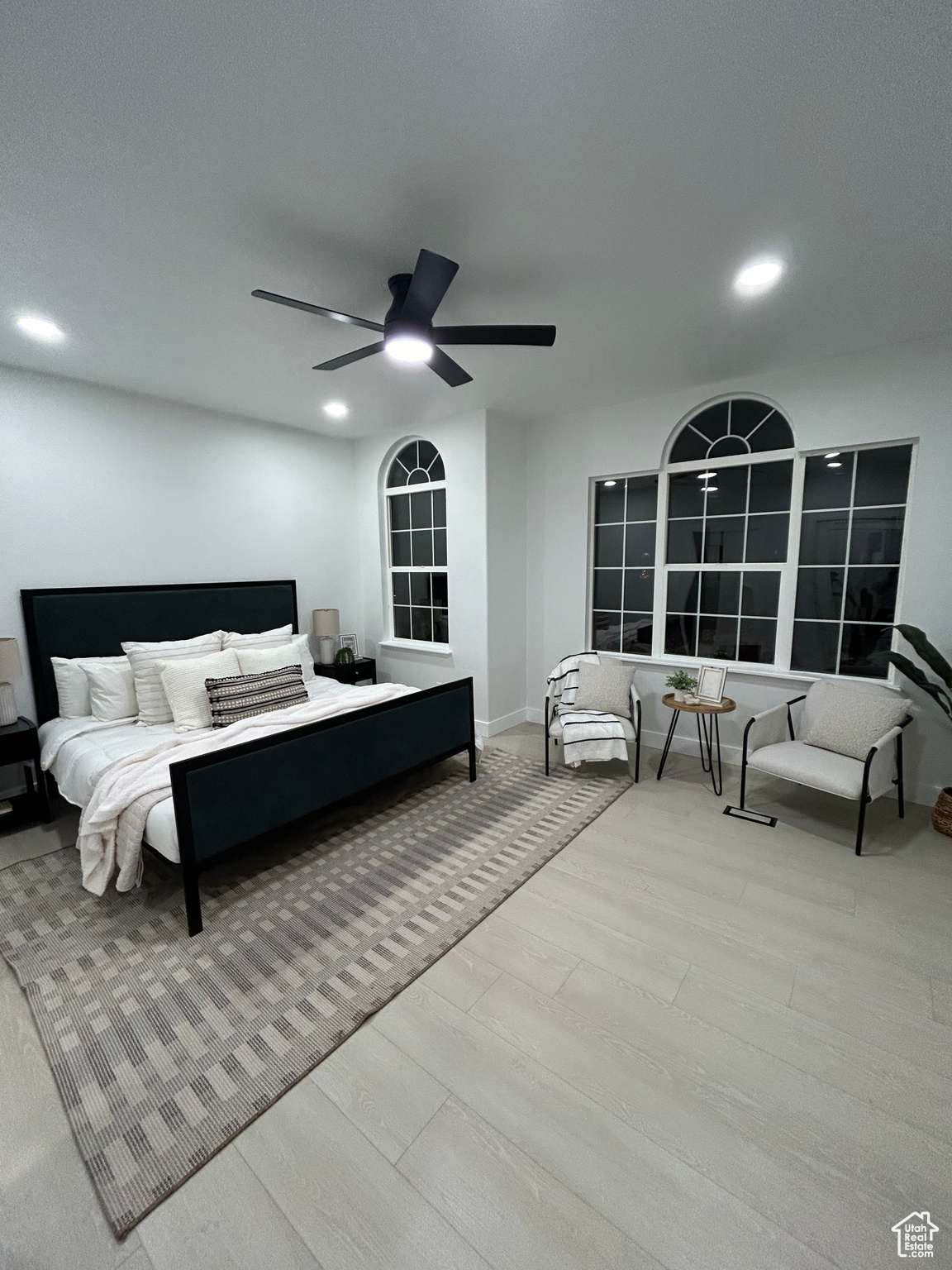 Bedroom with ceiling fan and light wood-type flooring