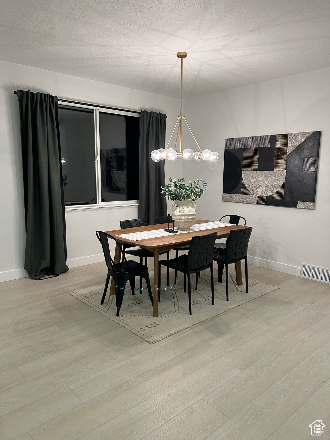 Dining room featuring a textured ceiling and light wood-type flooring