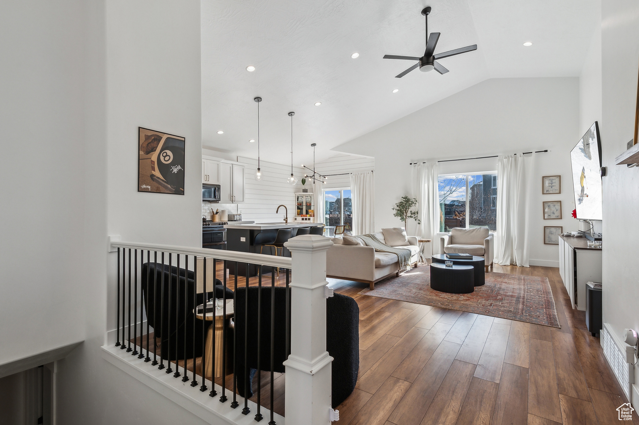 Interior space with ceiling fan, sink, dark hardwood / wood-style floors, and high vaulted ceiling