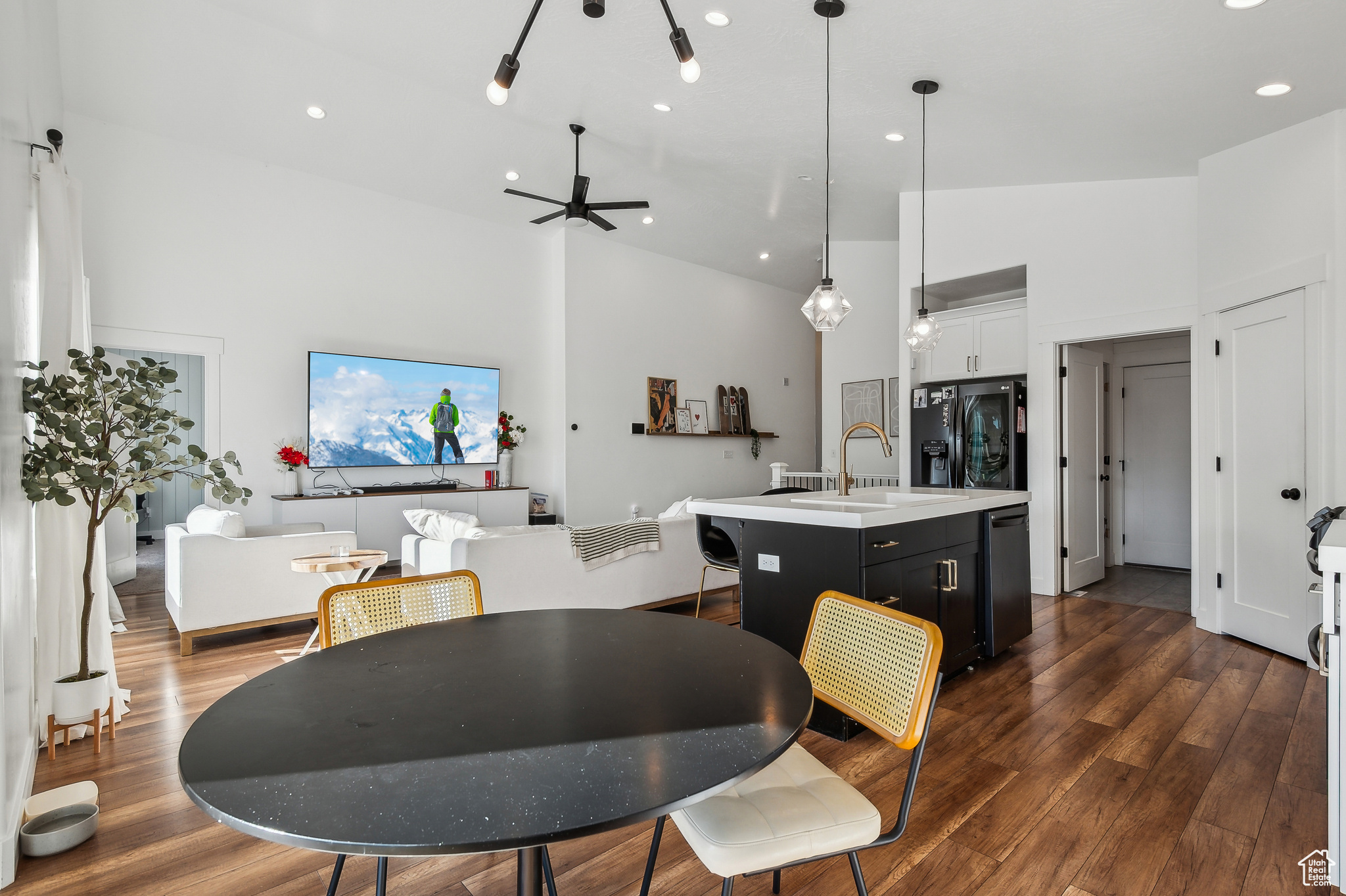 Dining room with ceiling fan, a towering ceiling, dark hardwood / wood-style floors, and sink