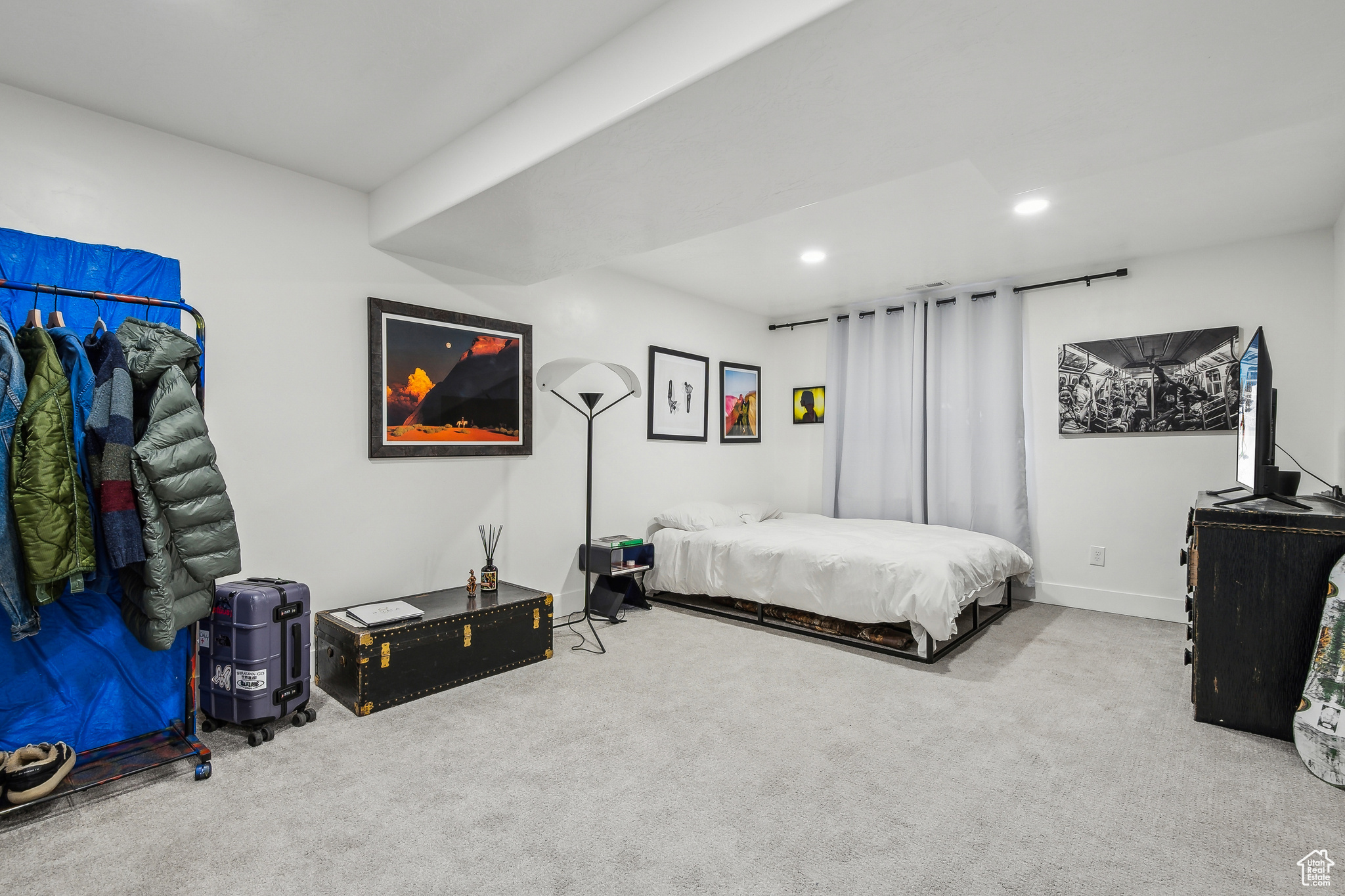 Bedroom featuring light colored carpet