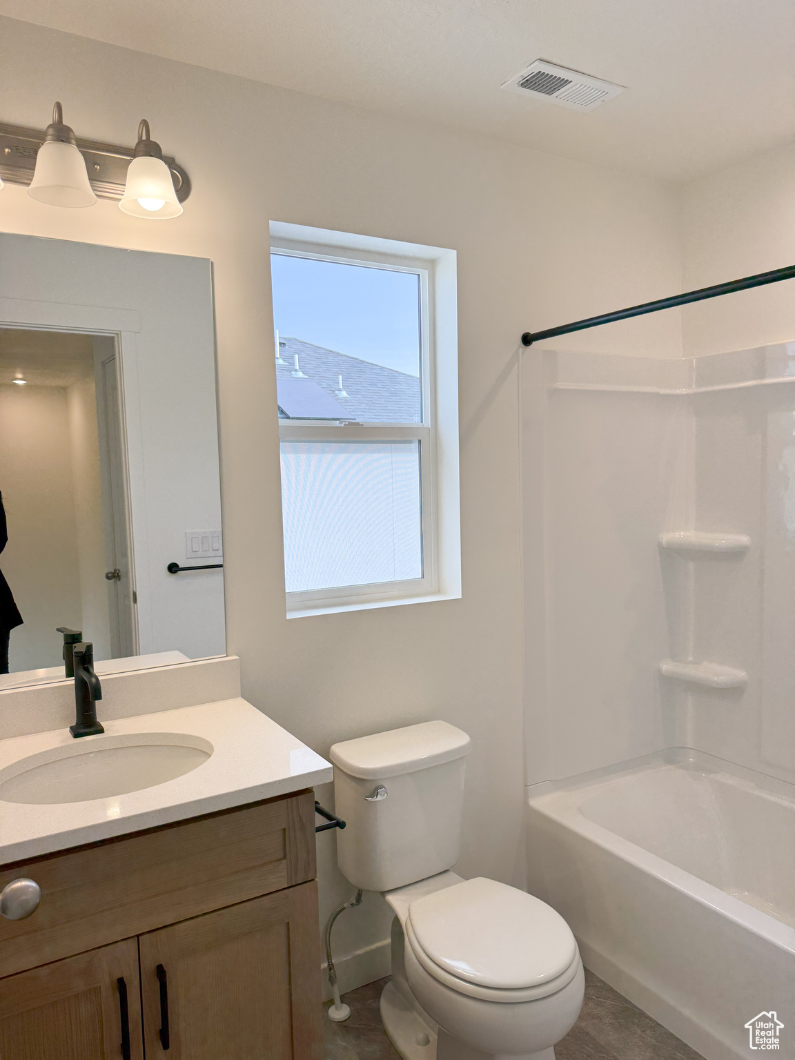 Full bathroom featuring vanity, toilet, and bathtub / shower combination