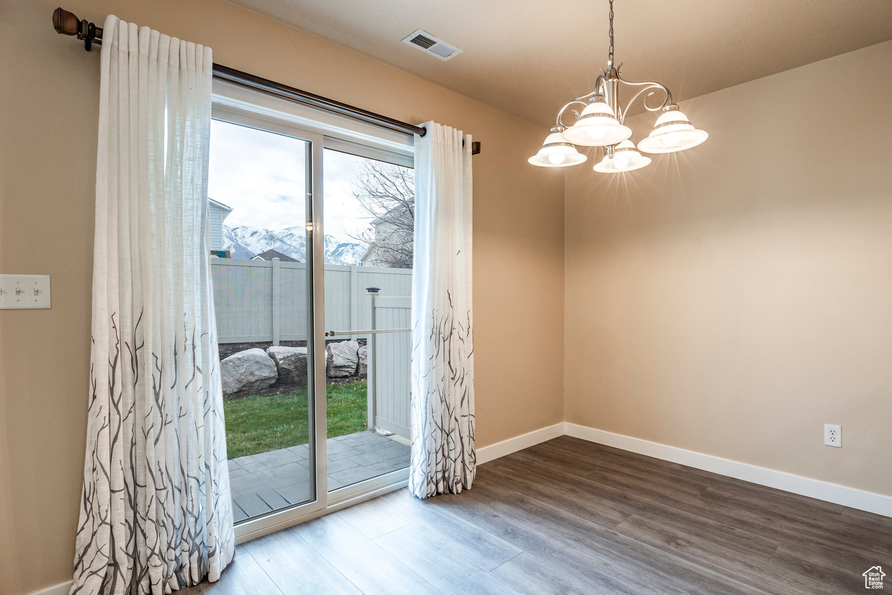 Entryway with a mountain view, hardwood / wood-style floors, and a chandelier