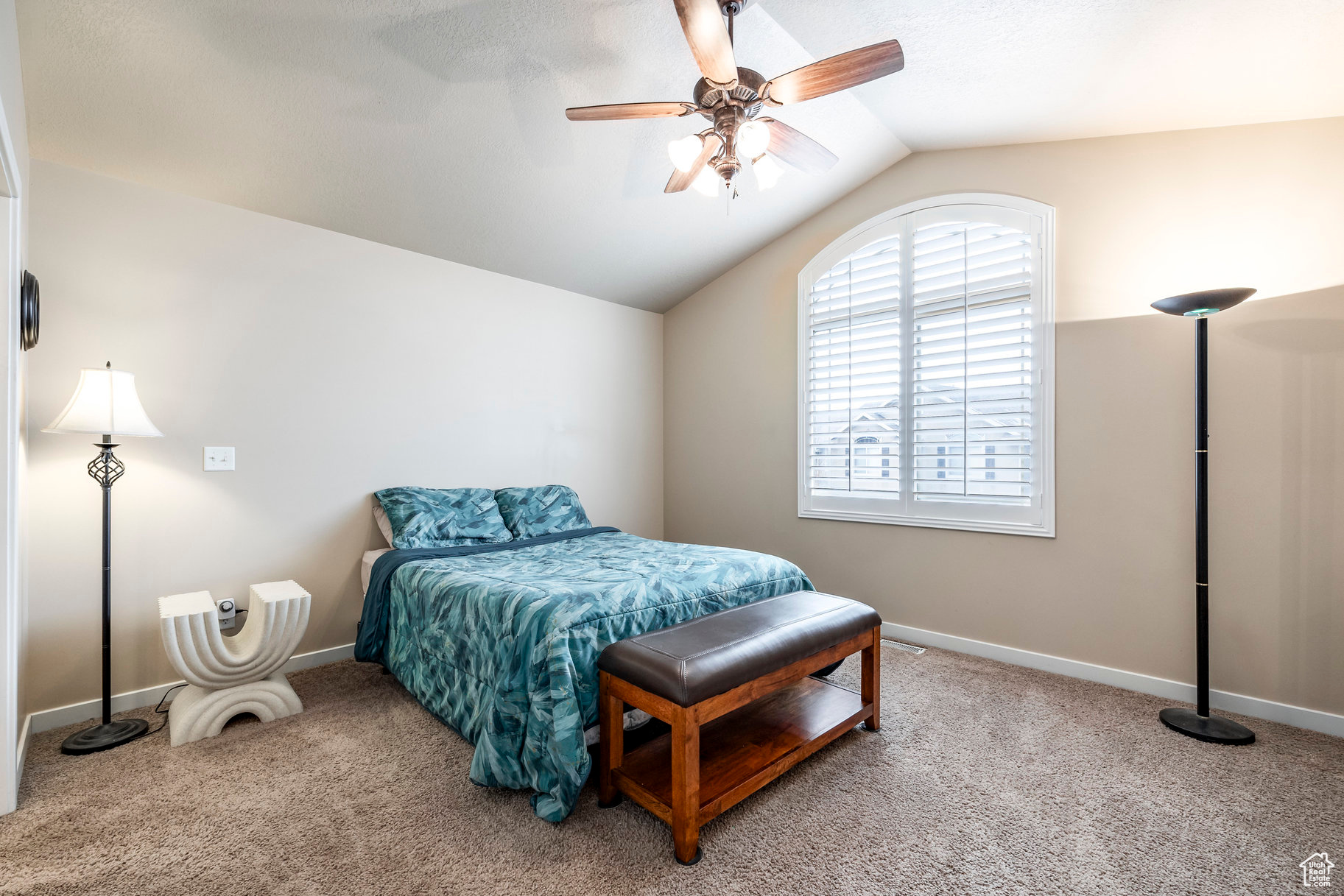 Bedroom with carpet, vaulted ceiling, and ceiling fan