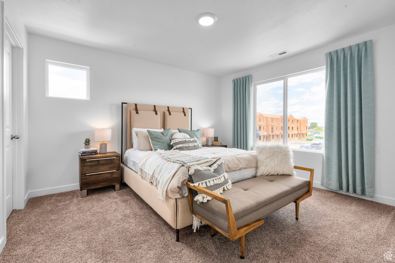 Bedroom featuring carpet and multiple windows