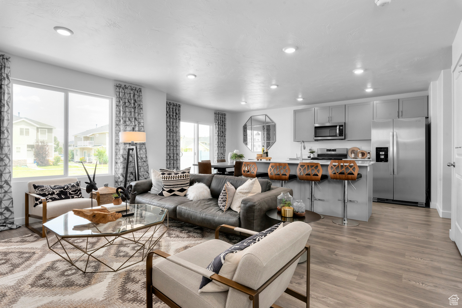 Living room with light hardwood / wood-style floors and sink