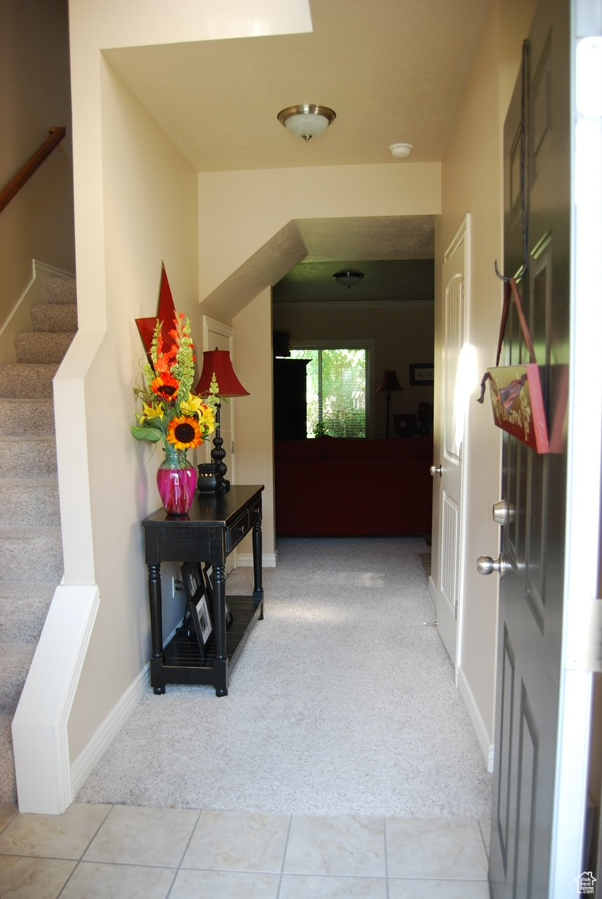 Hall featuring light colored carpet