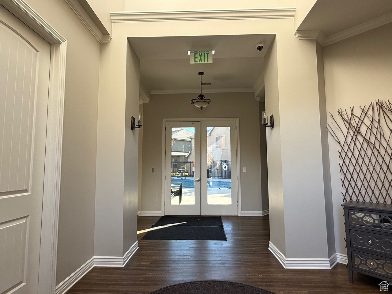 Doorway featuring crown molding, french doors, and dark hardwood / wood-style floors