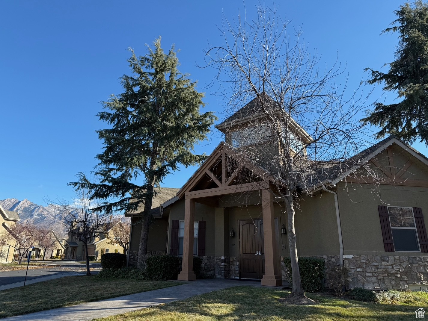 View of front of Clubhouse with a mountain view and a front yard