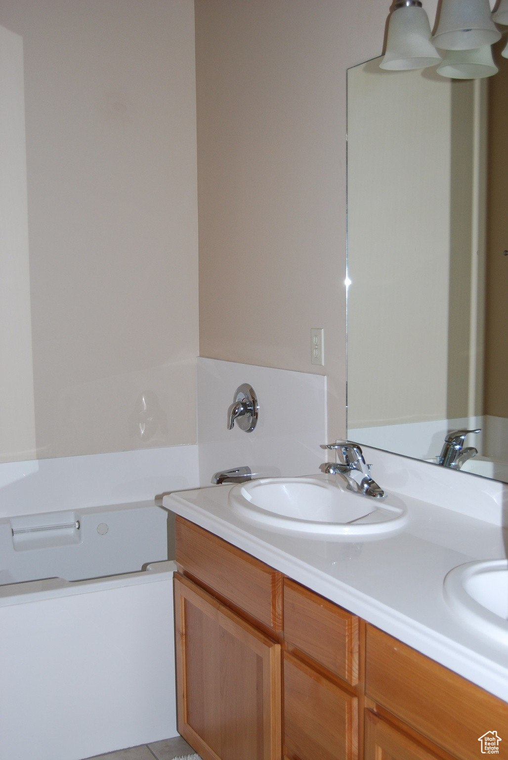 Bathroom featuring a tub to relax in and vanity