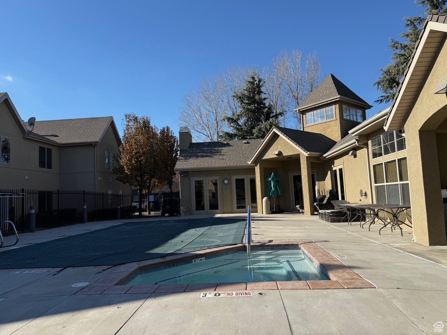 View of pool featuring a community hot tub, a patio, and french doors