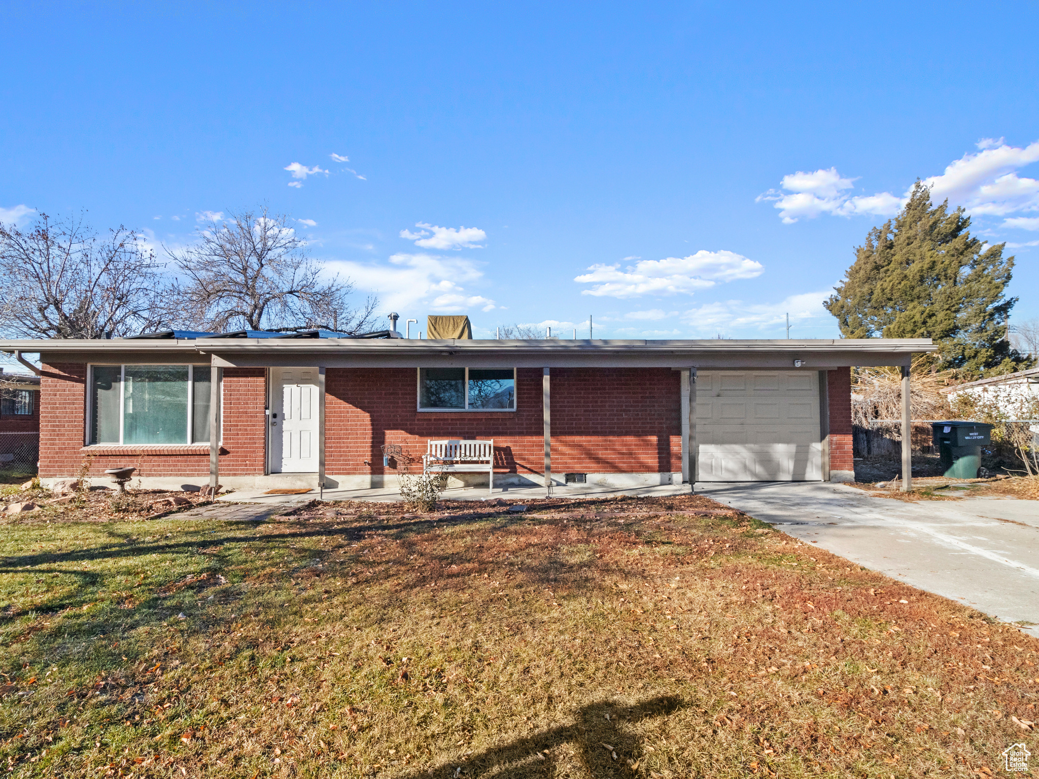 Ranch-style home with a garage and a front lawn