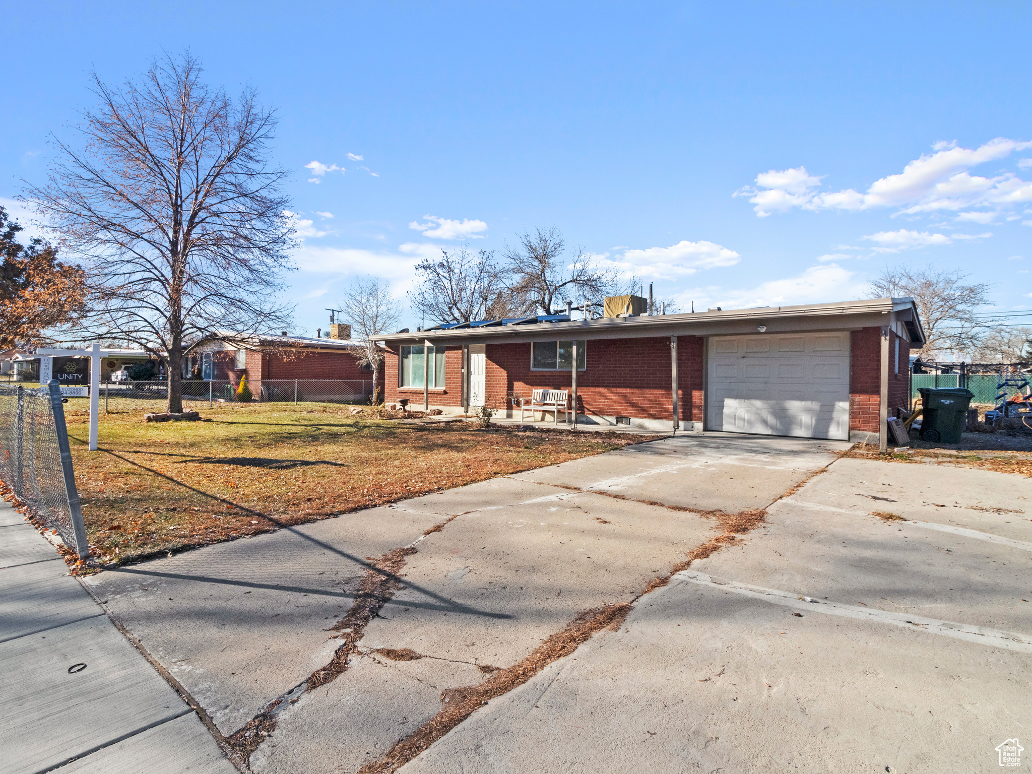 Ranch-style home featuring a garage and a front yard