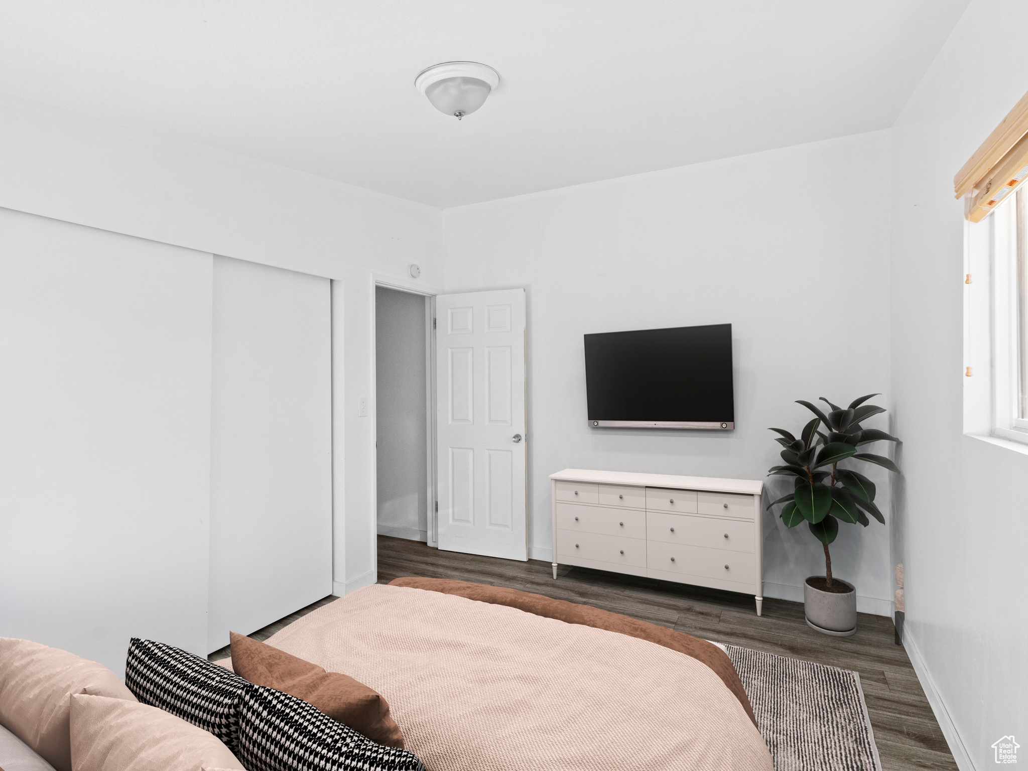 Bedroom featuring a closet and dark hardwood / wood-style flooring